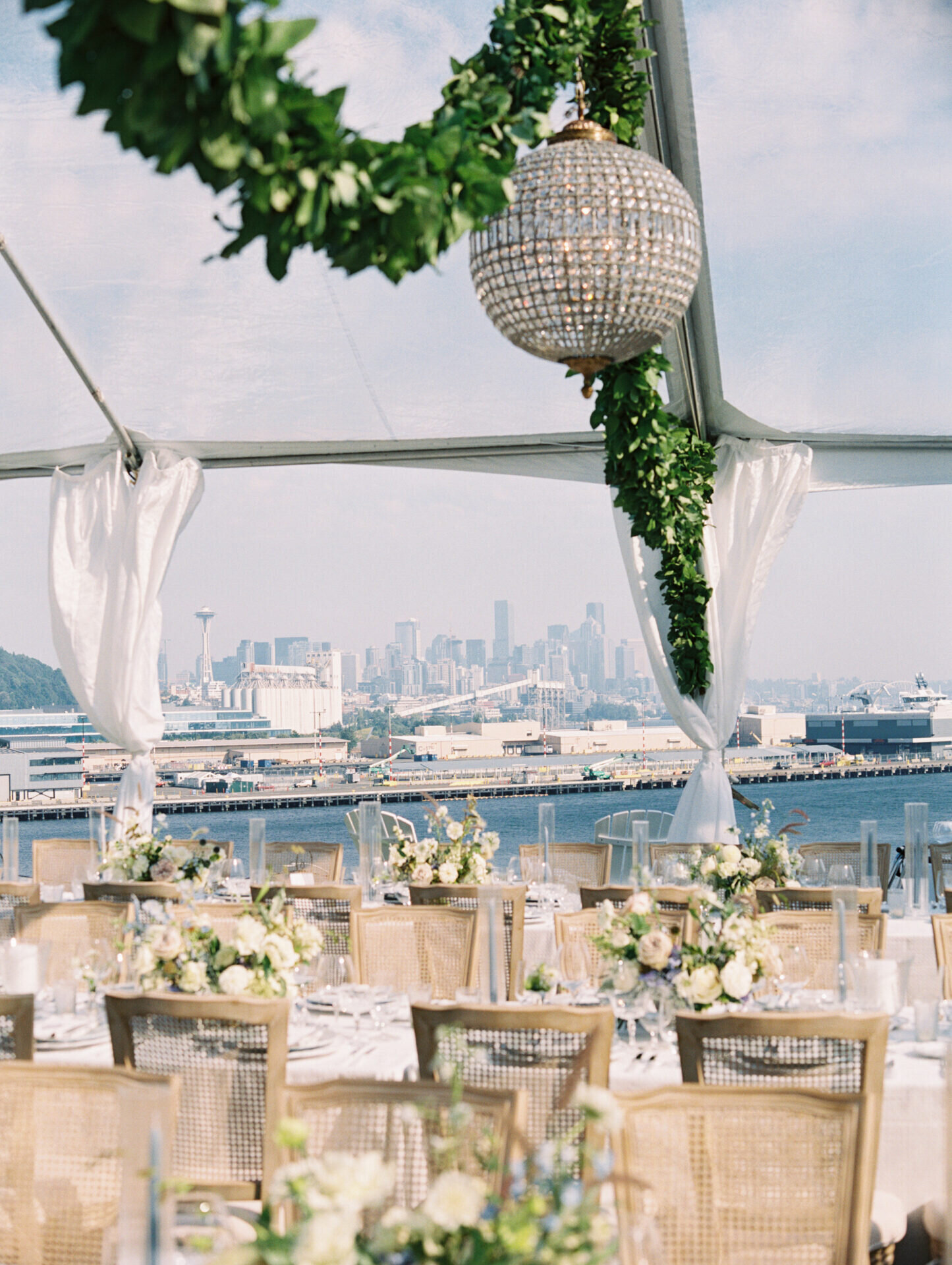 coastal reception tables with blue views of water and seattle in the background
