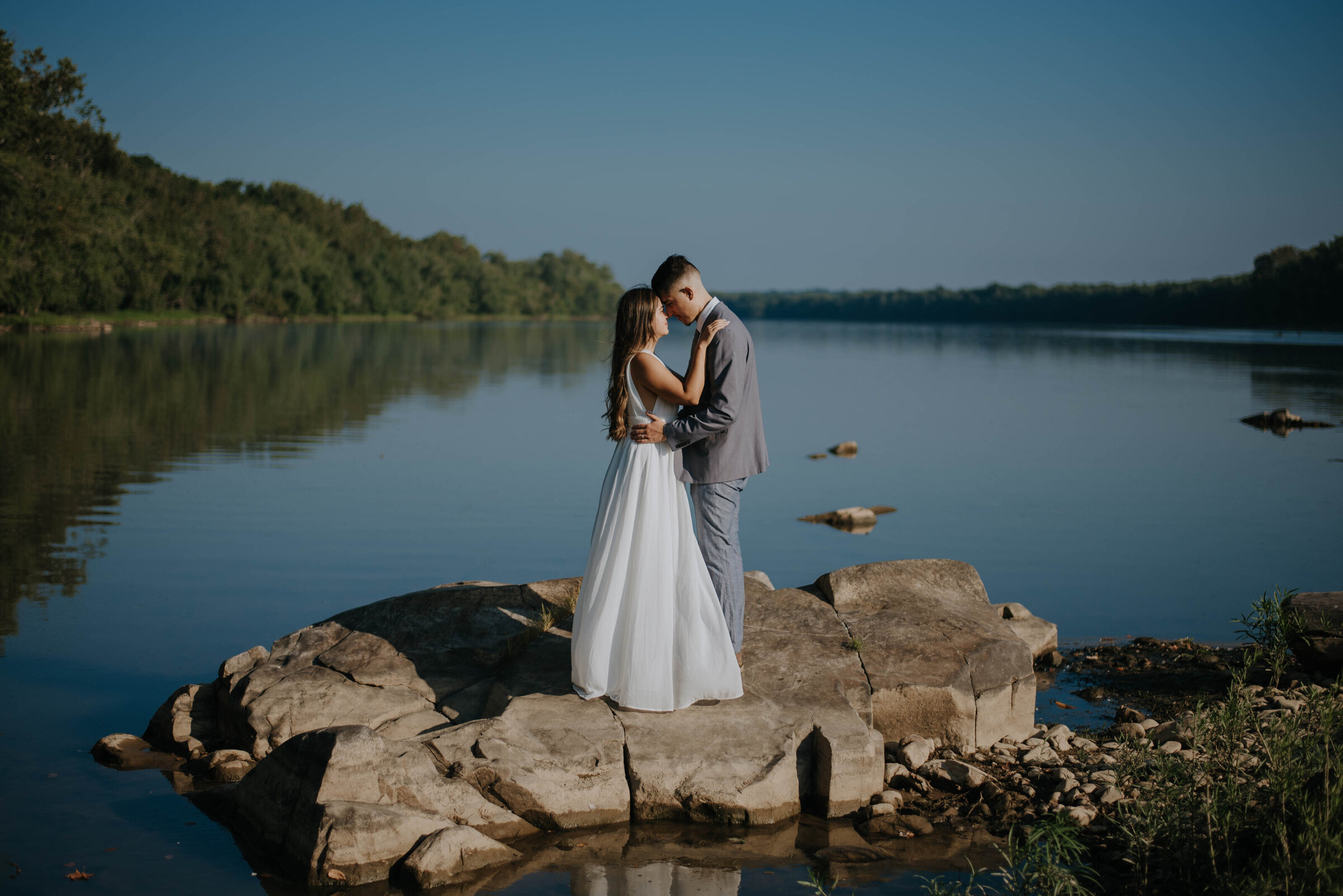Virginia bride and groom posed on rock along the coast