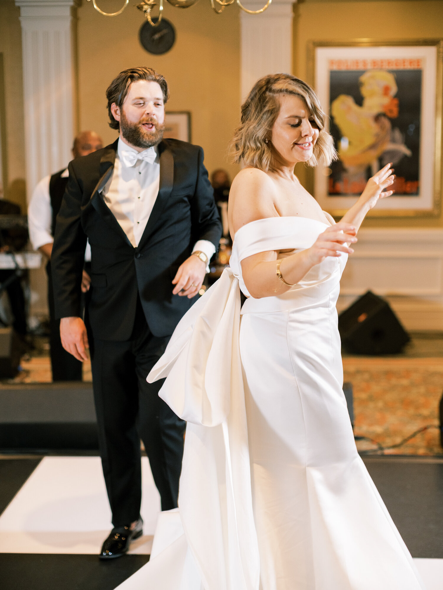 bride dances with groom on checkerboard dance floor