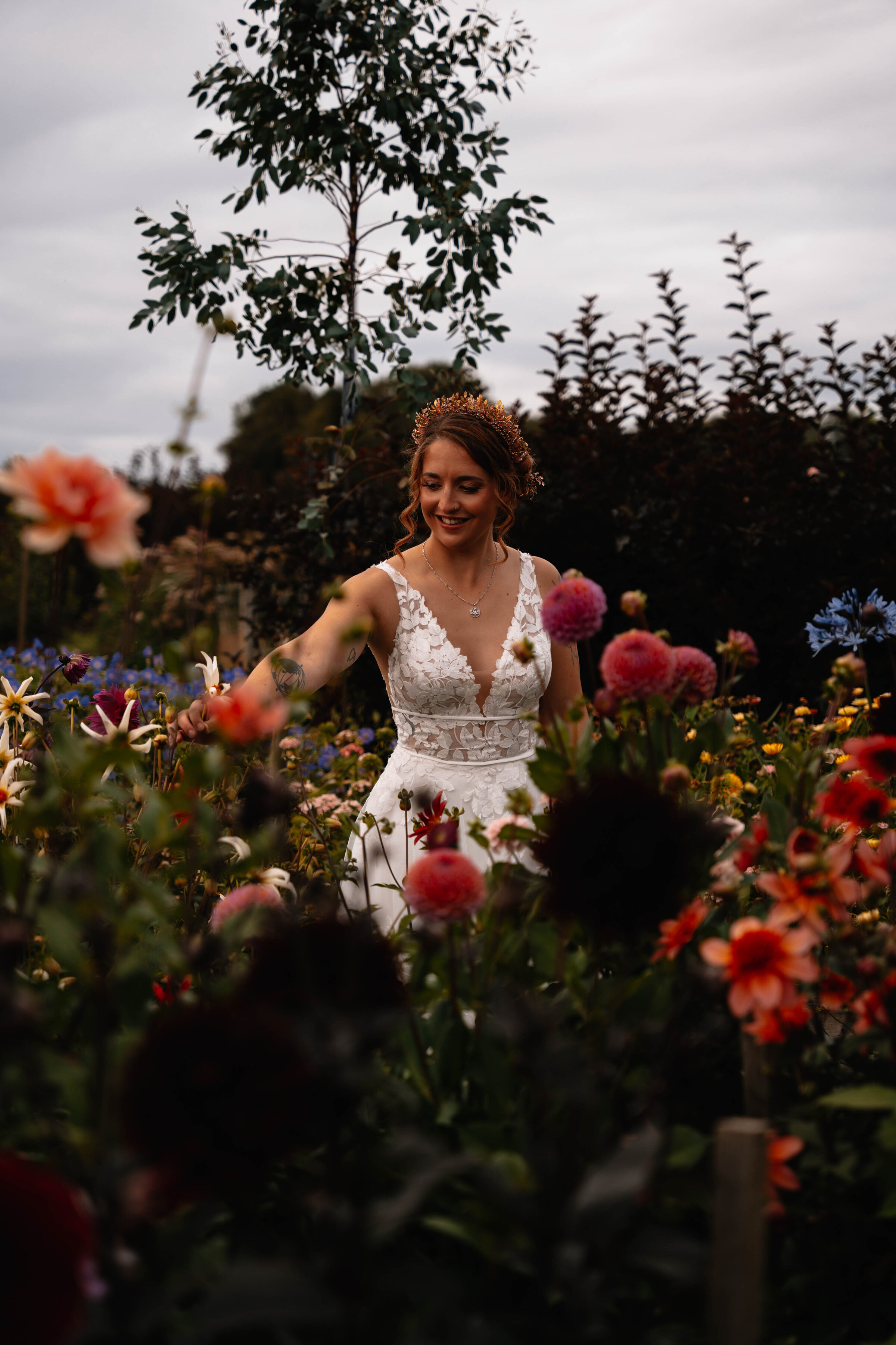 Bride in wedding dress surrounded by wildflowers