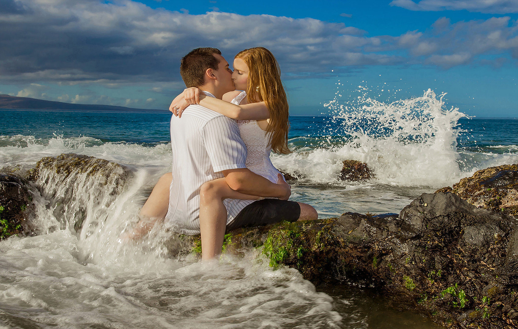 couple in love kissing on the rocks on Maui.
