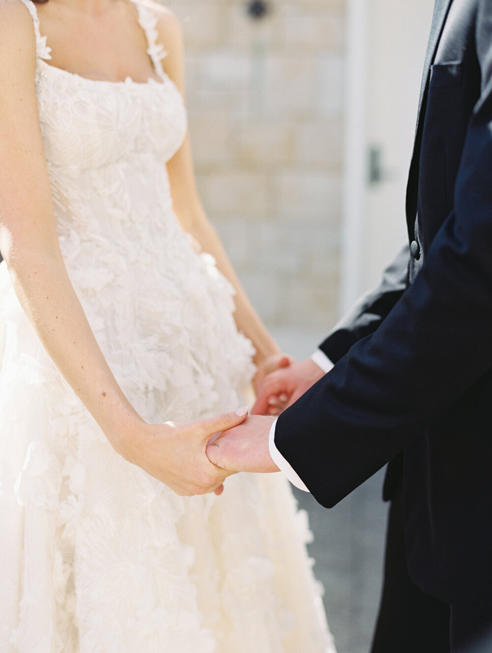 bride and groom hands holding up close photo