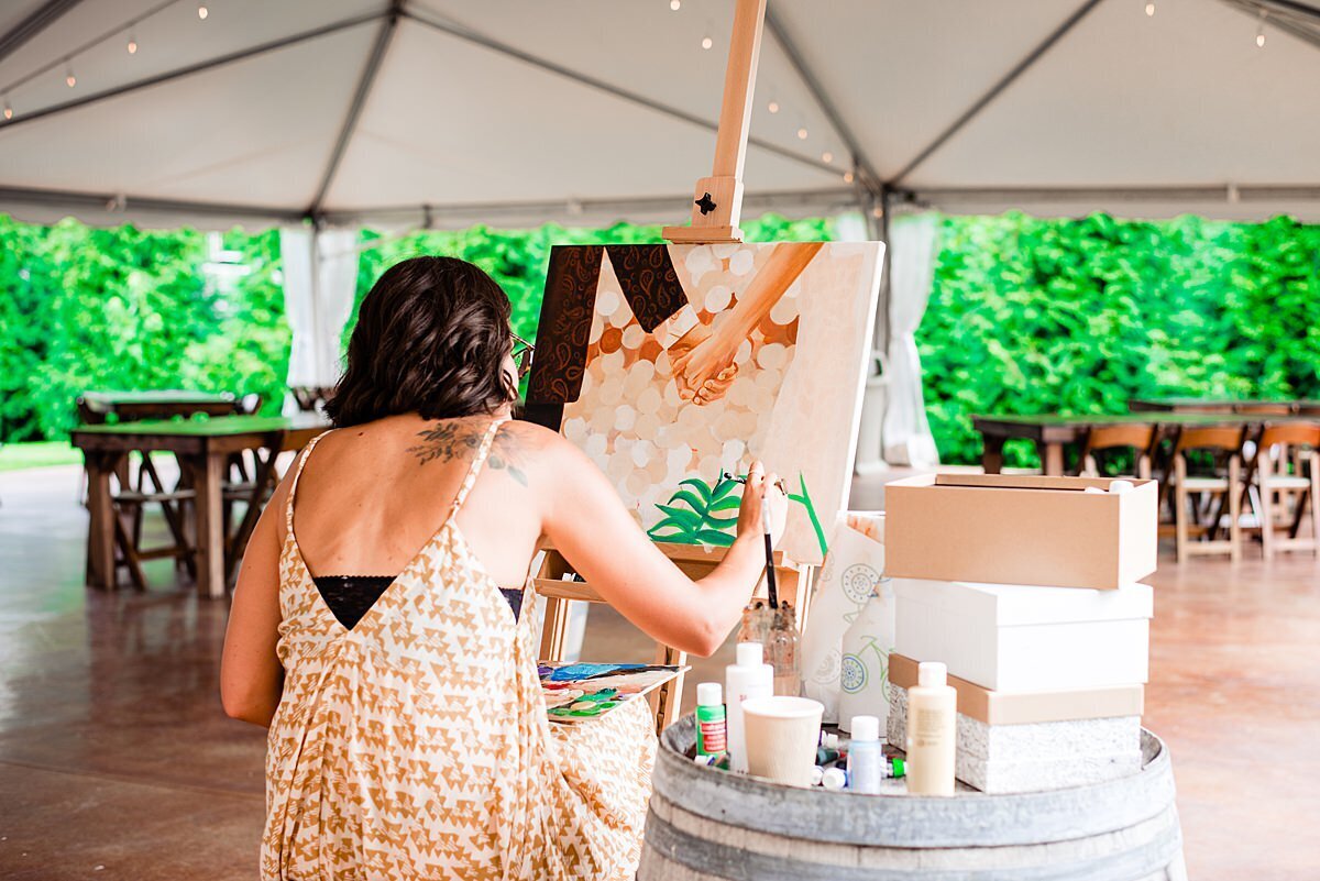 Live Event Painter working on custom painting for bride and groom during their wedding reception at Arrington Vineyards