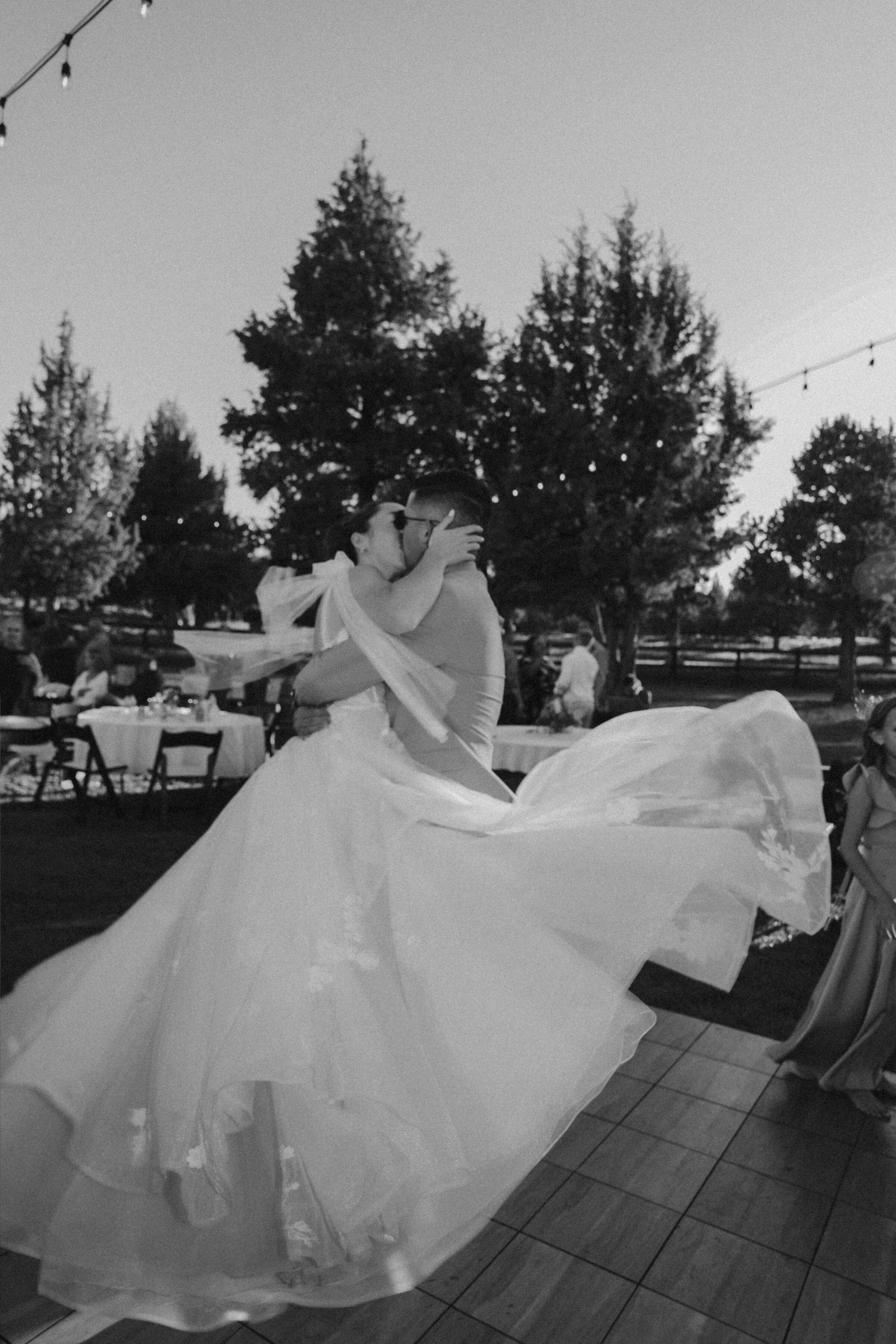Oregon Wedding Reception Dance – Bride and Groom Twirl in Black and White