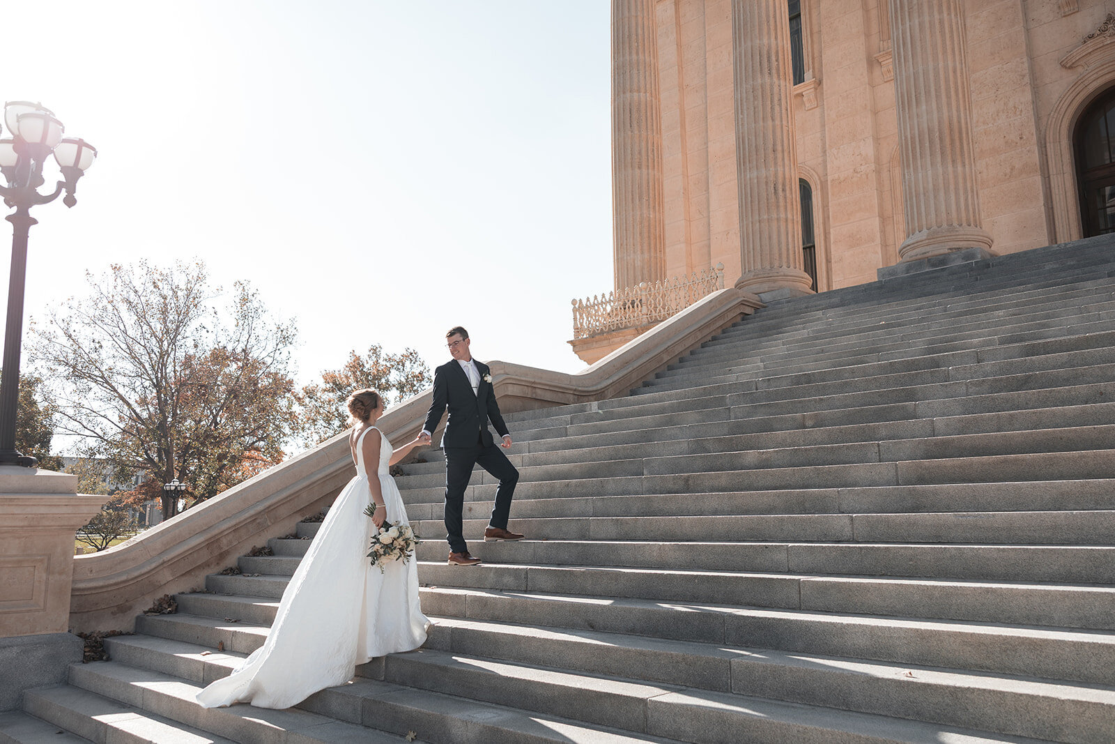 bride and groom walking in an urban landscape in downtown Kansas City.