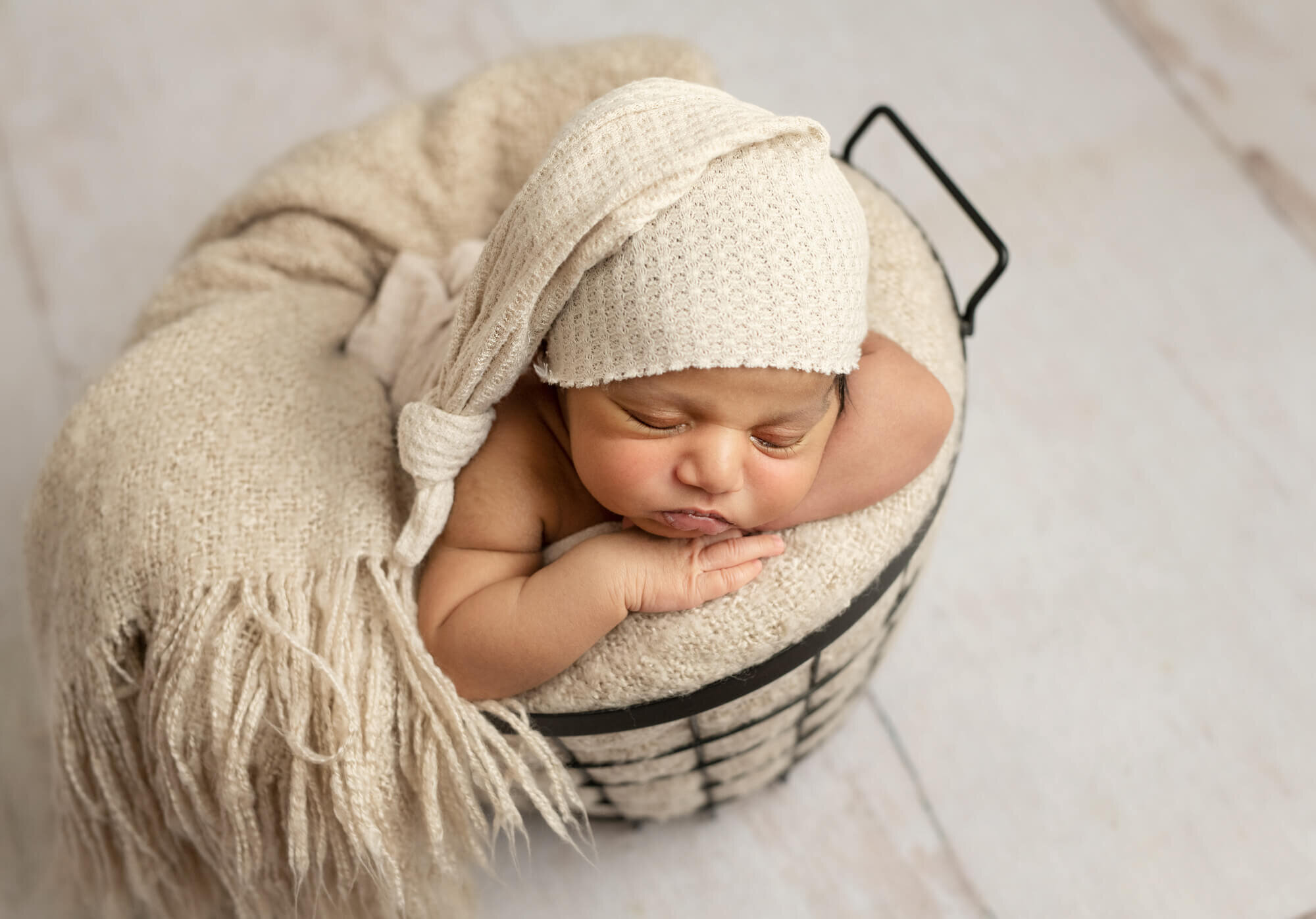 Baby in cream sleepy cap sleeping