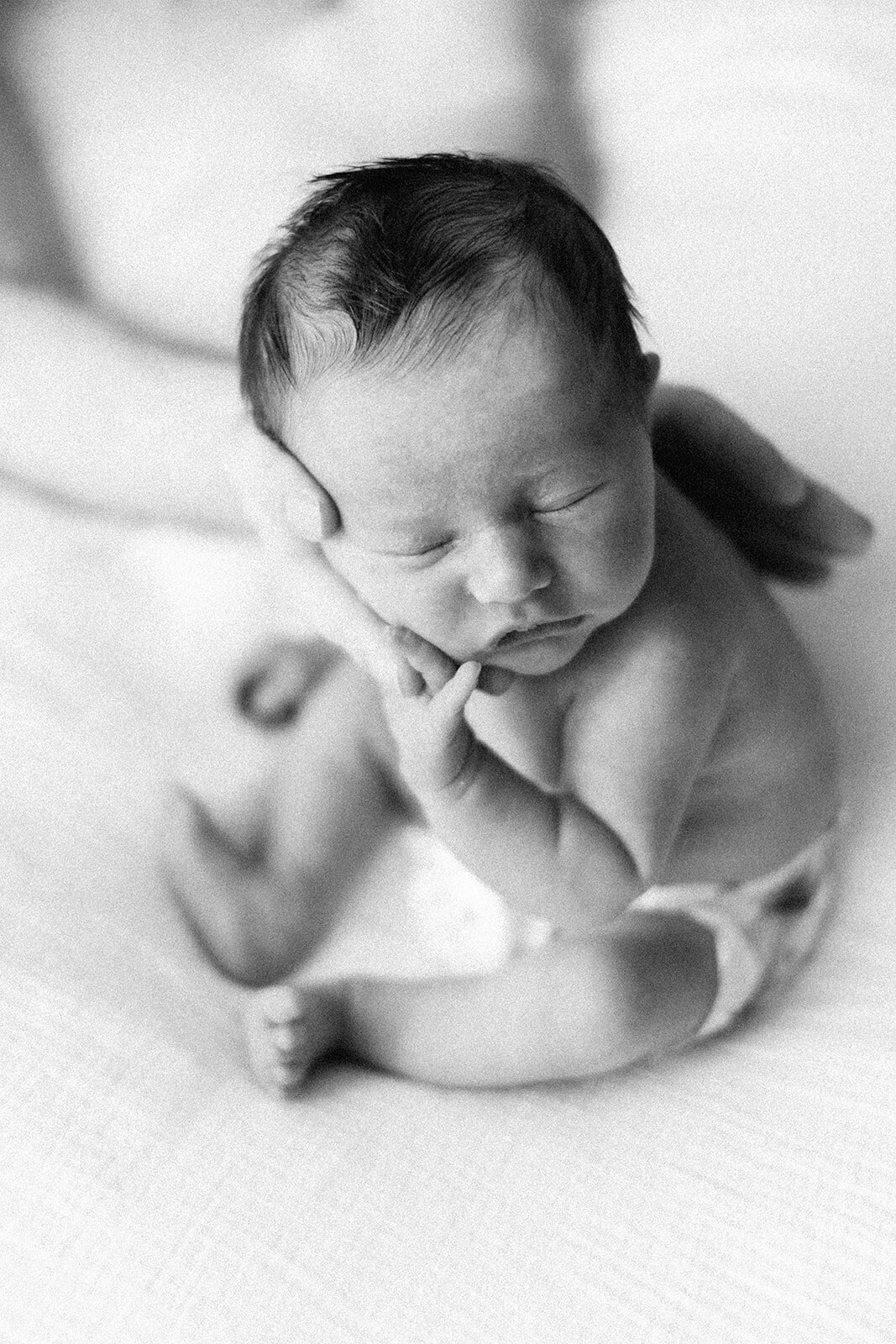 baby photo in BW of baby being burped 
