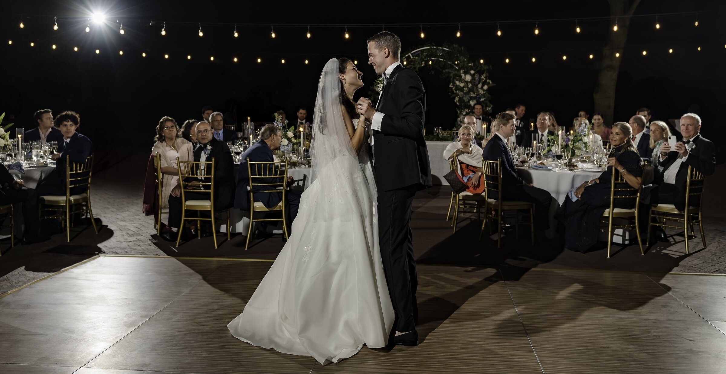 Bride and groom share first dance on an outdoor dance floor in Chicago, IL