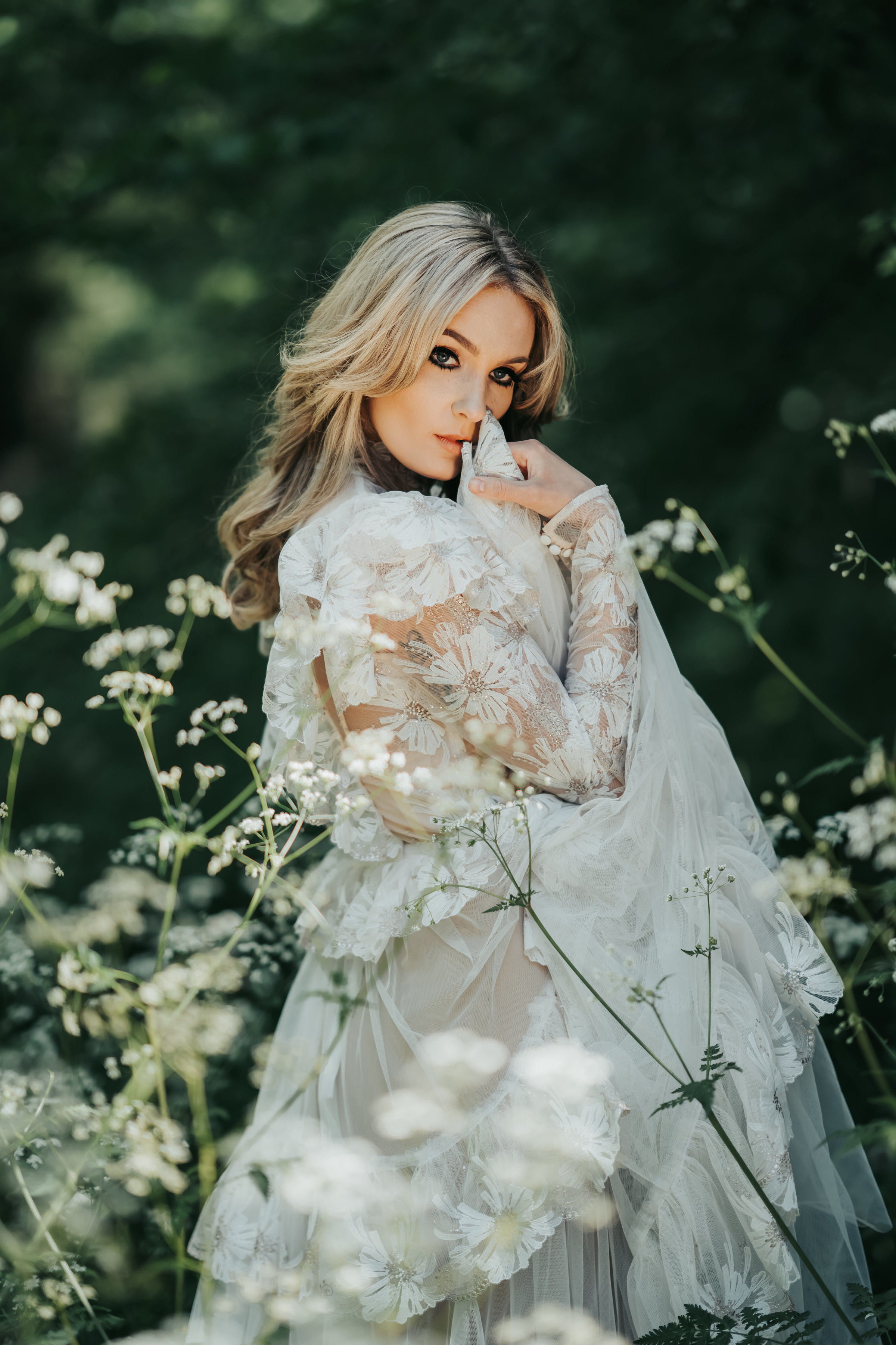 Blushing bridal portrait at her woodland wedding