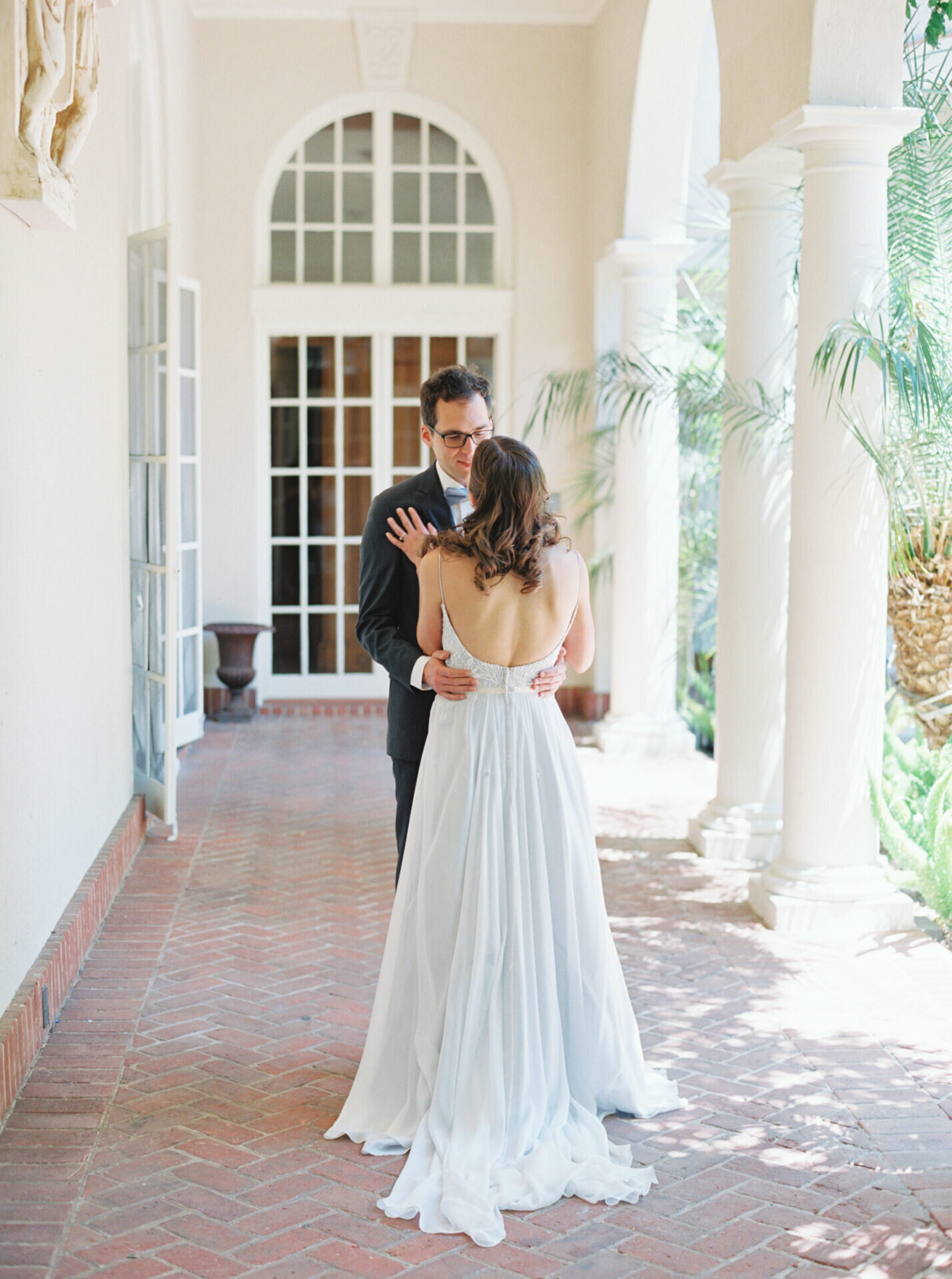 bride places hand on grooms chest at first look