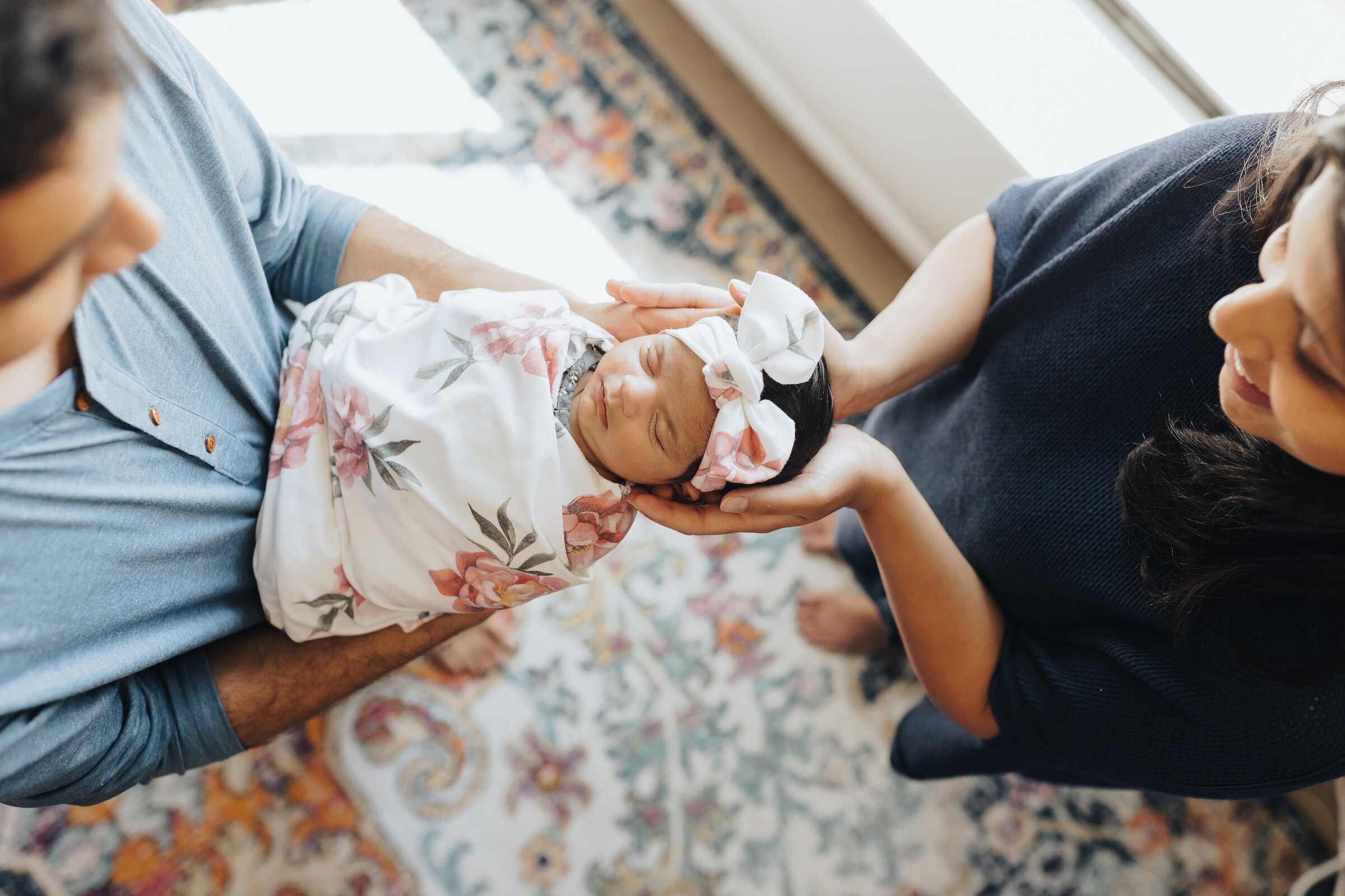 Baby Swaddled in Flower Swaddle Held by both parents