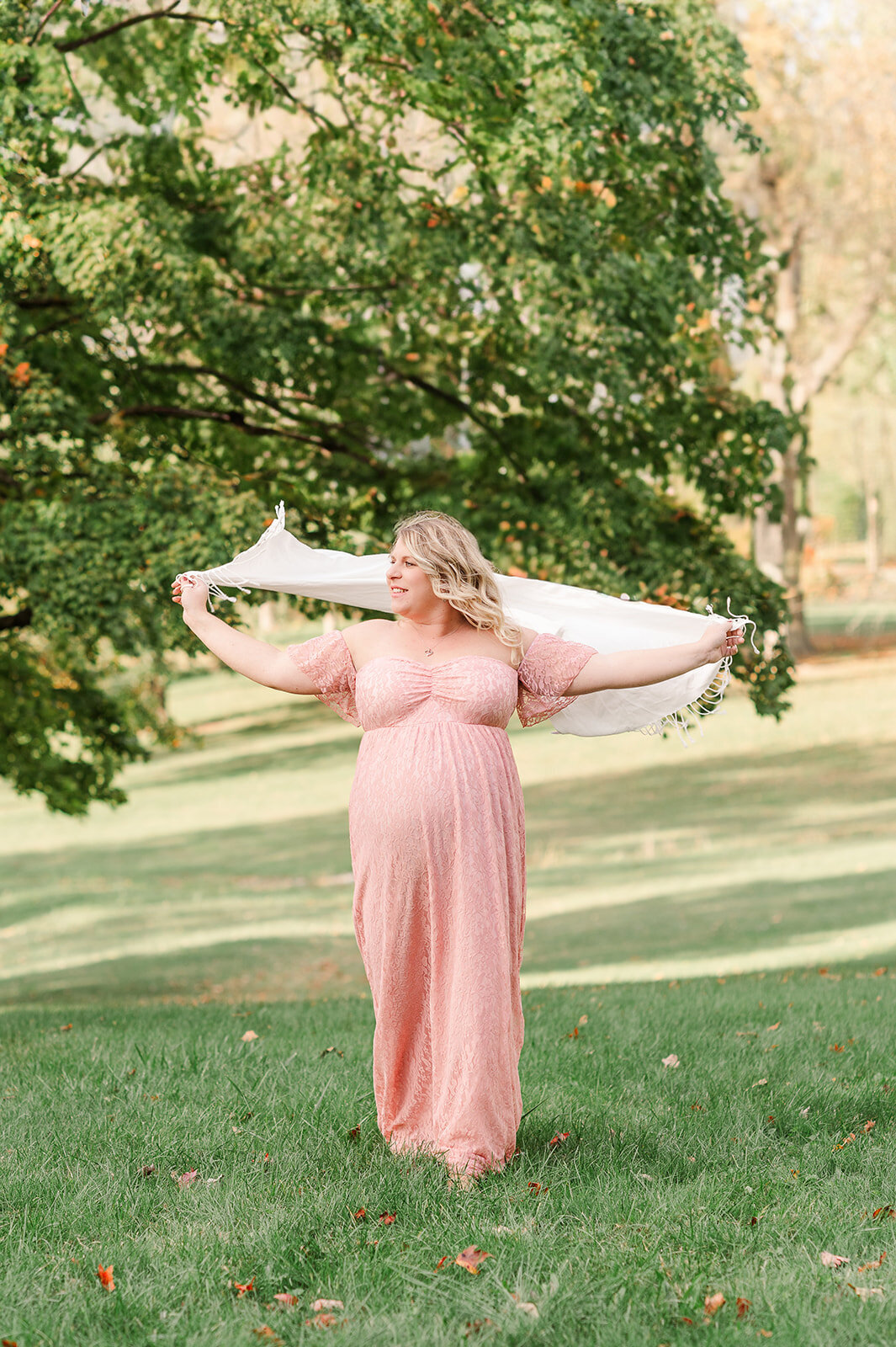 maternity session in park with mother holding scarf up in the wild in baltimore md