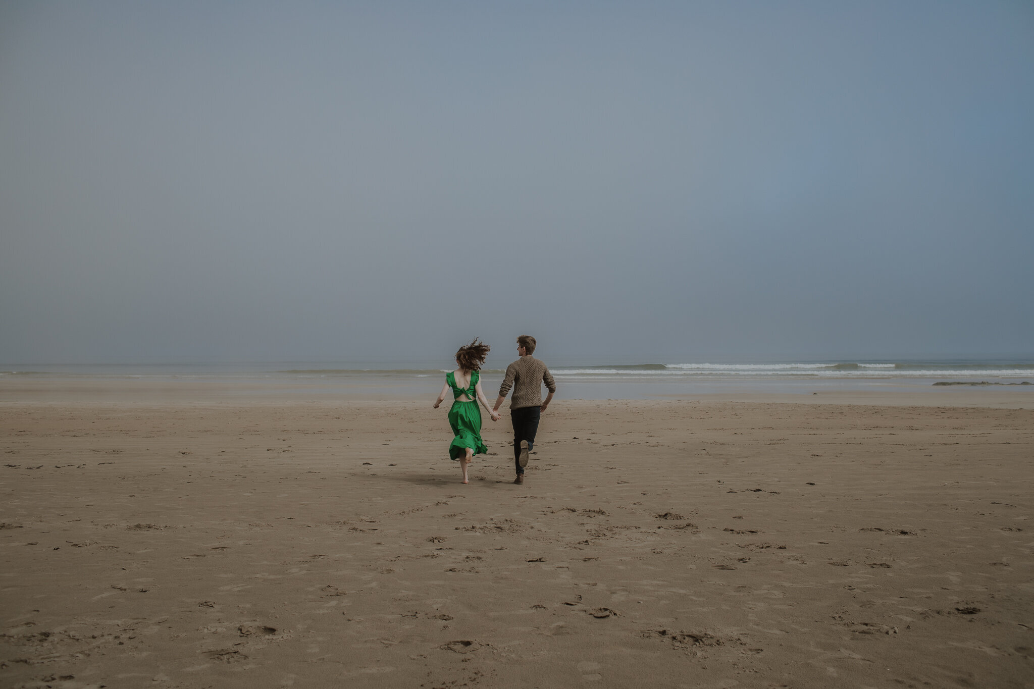 couple running on the beach