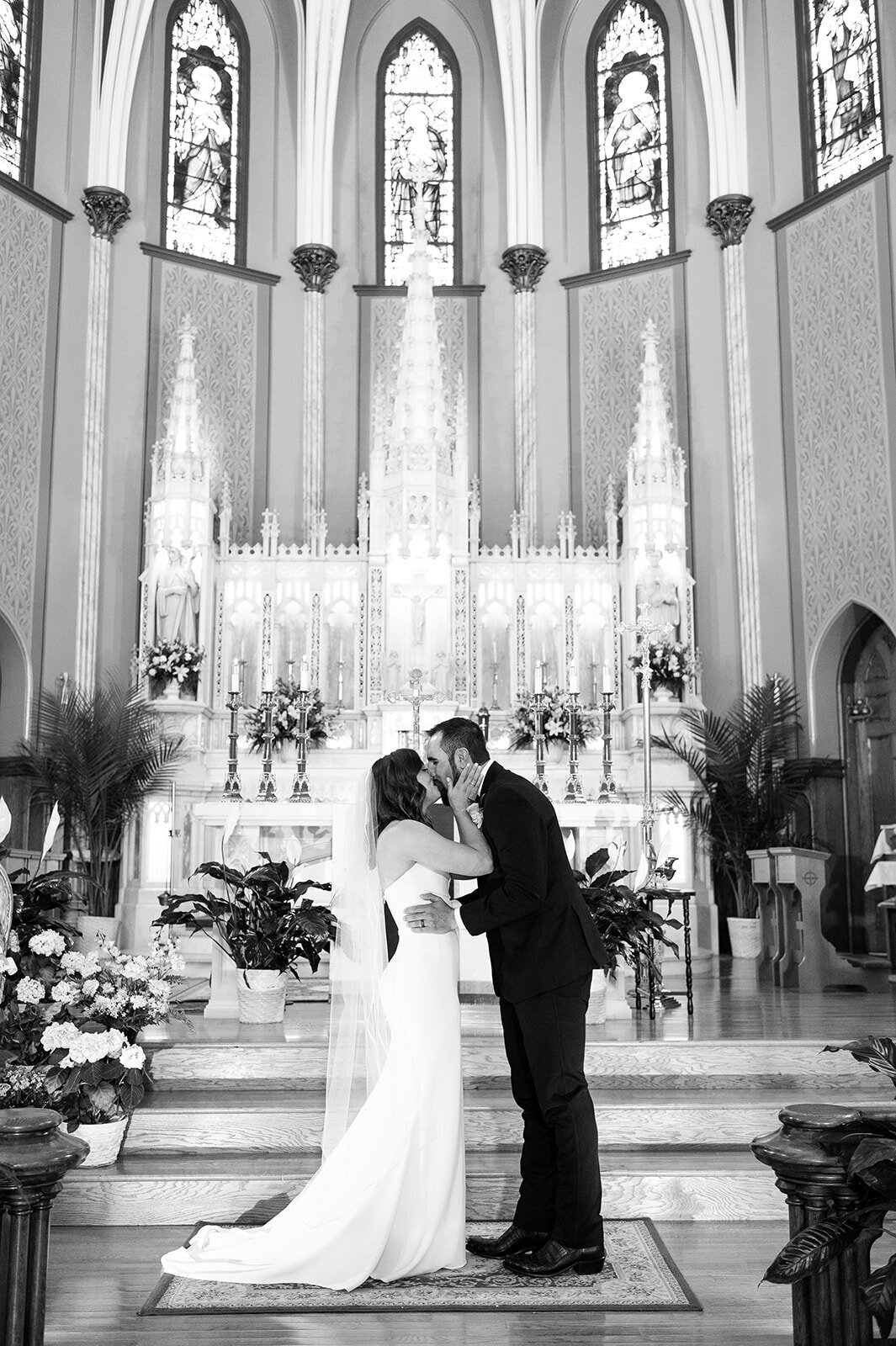 canfield casino wedding with the bride and groom kissing during their wedding ceremony at the church
