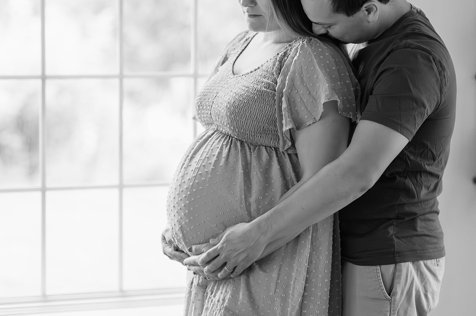 maternity session at home with mother and father embracing in baltimore md