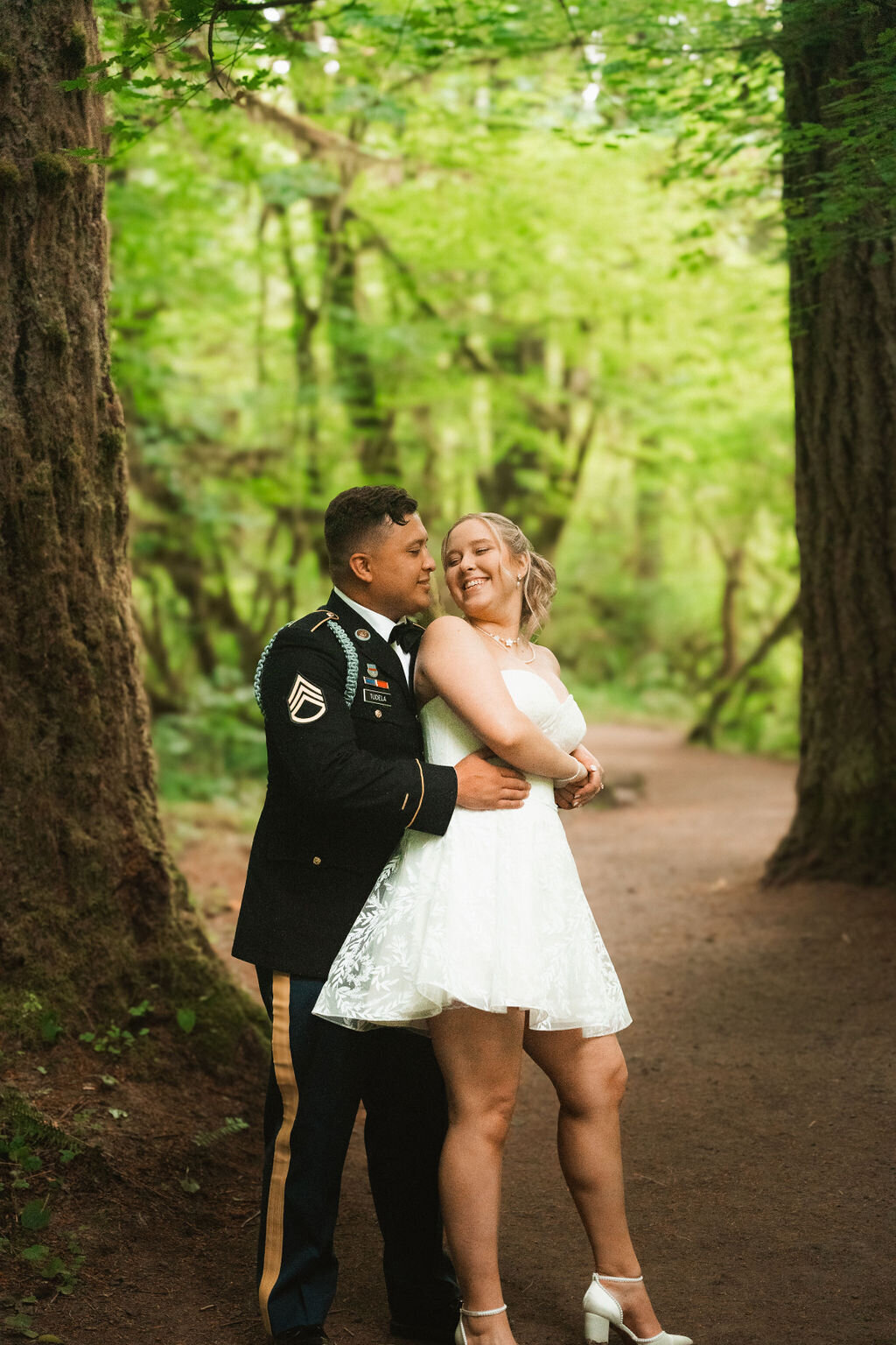 elopement in the forest in oregon a military couple dancing together