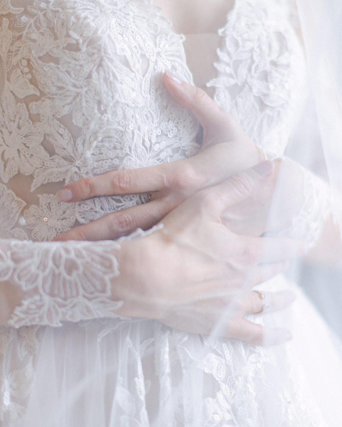 A luxurious and heartfelt photograph of a bride gently holding her chest, overwhelmed with emotion as her elopement at the Banff Springs Hotel is about to begin. Captured in the breathtaking surroundings of Banff National Park, this timeless image embodies the beauty, anticipation, and deep sentiment of an unforgettable wedding day.