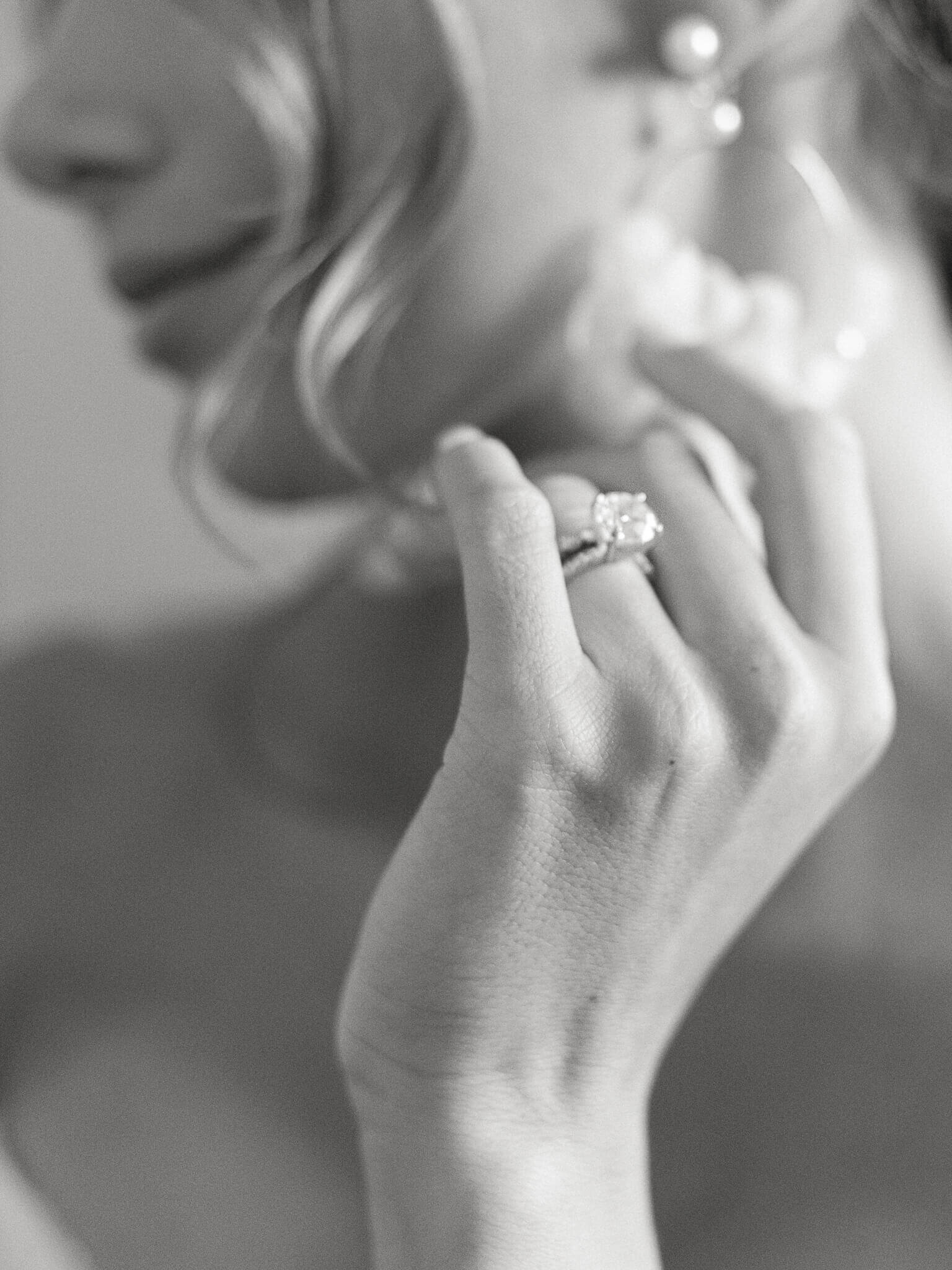 close up picture of bride wearing her diamond engagement ring