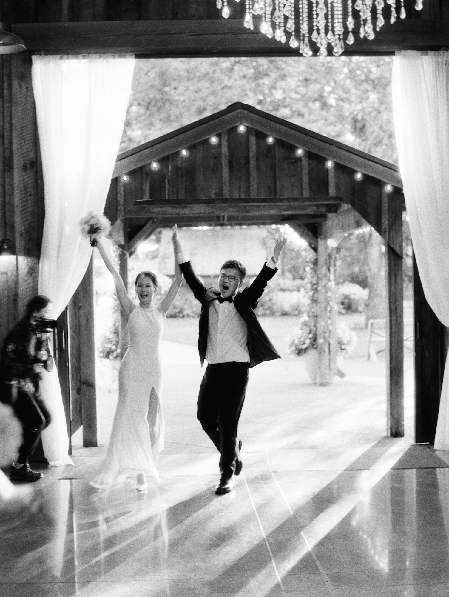 bride and groom exciting grand entrance black and white film