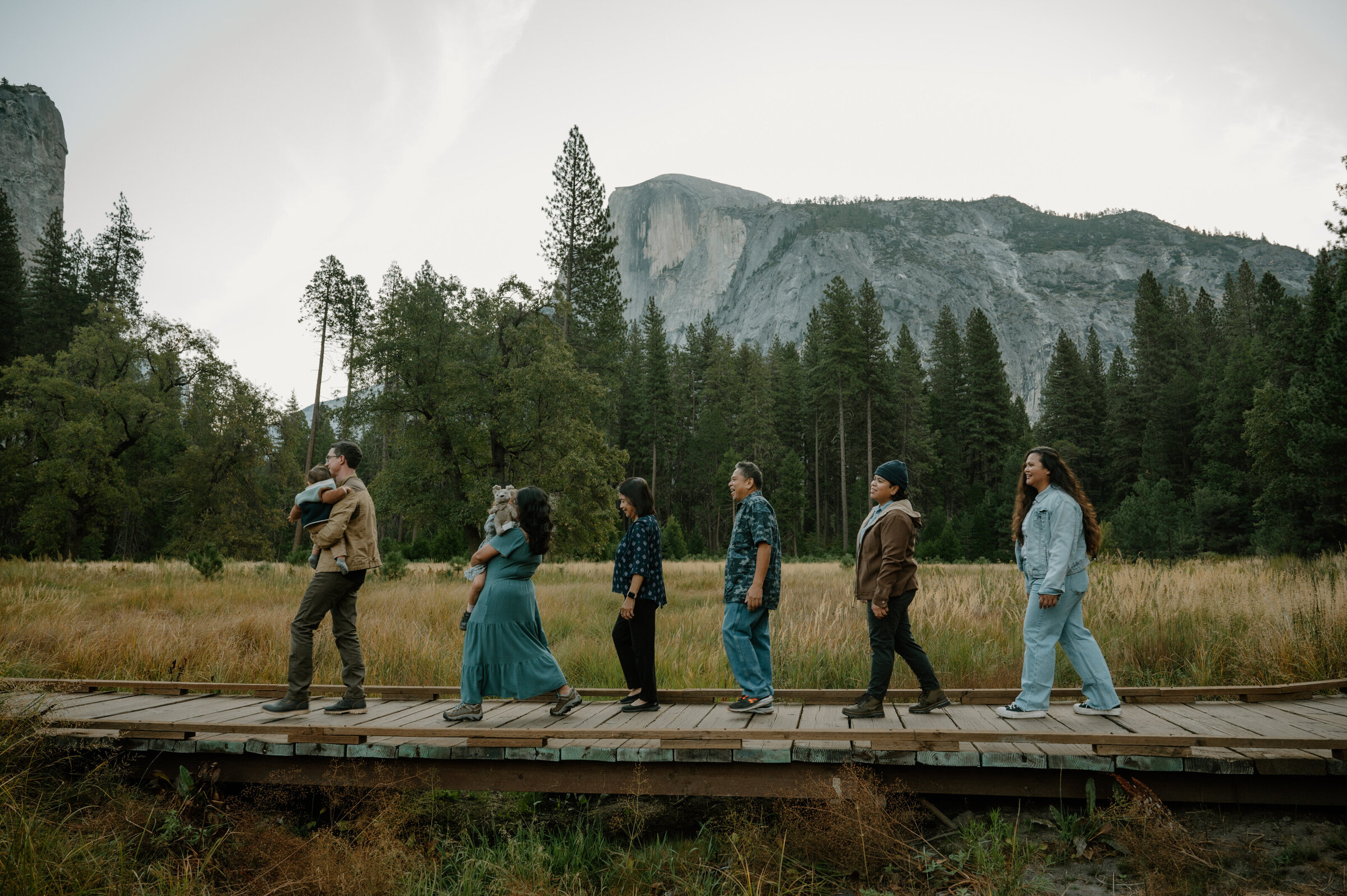 Grandparents, parents, and children smiling together during a generational family session in Yosemite