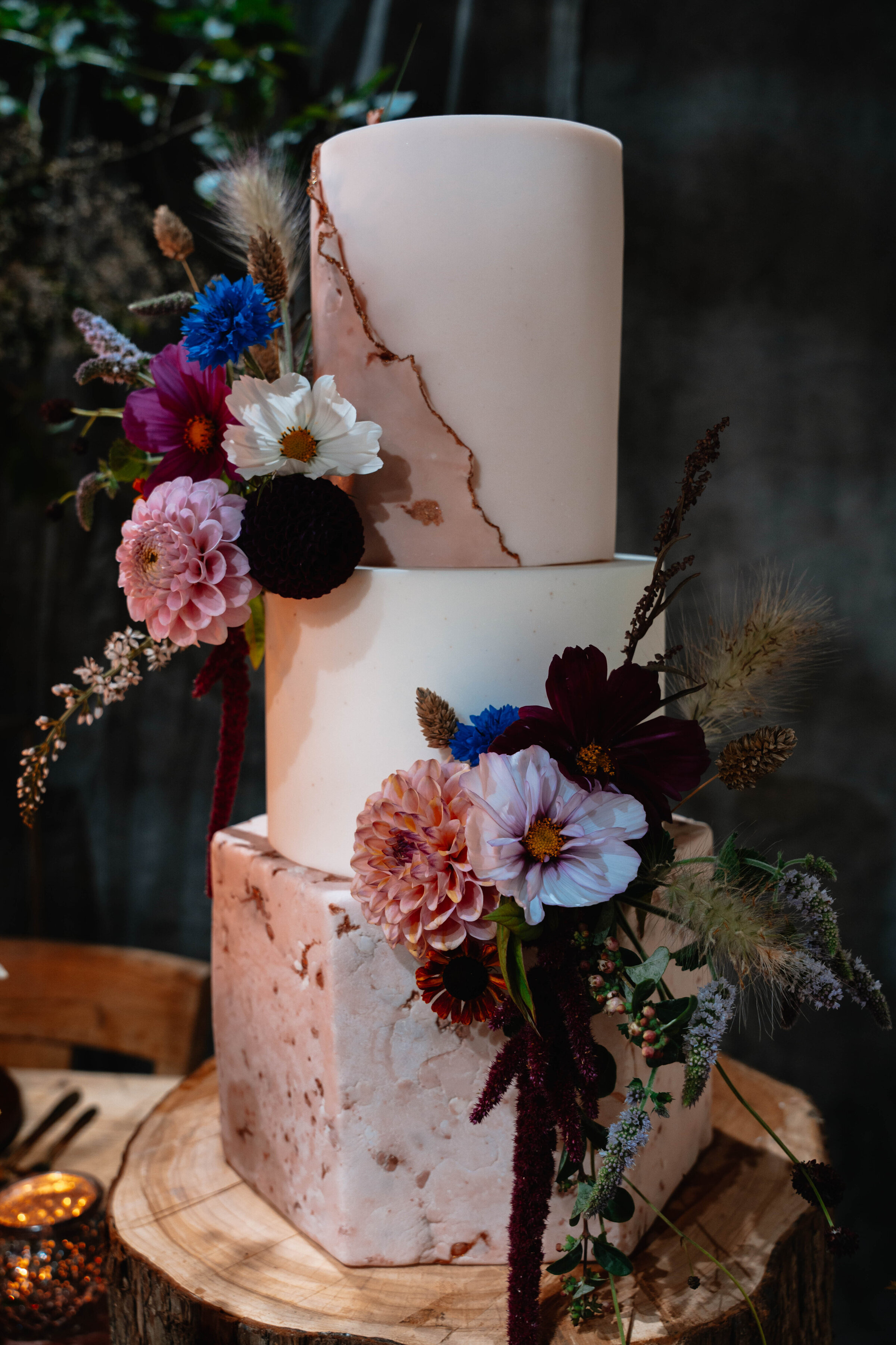 Three tier wedding cake with wild flowers