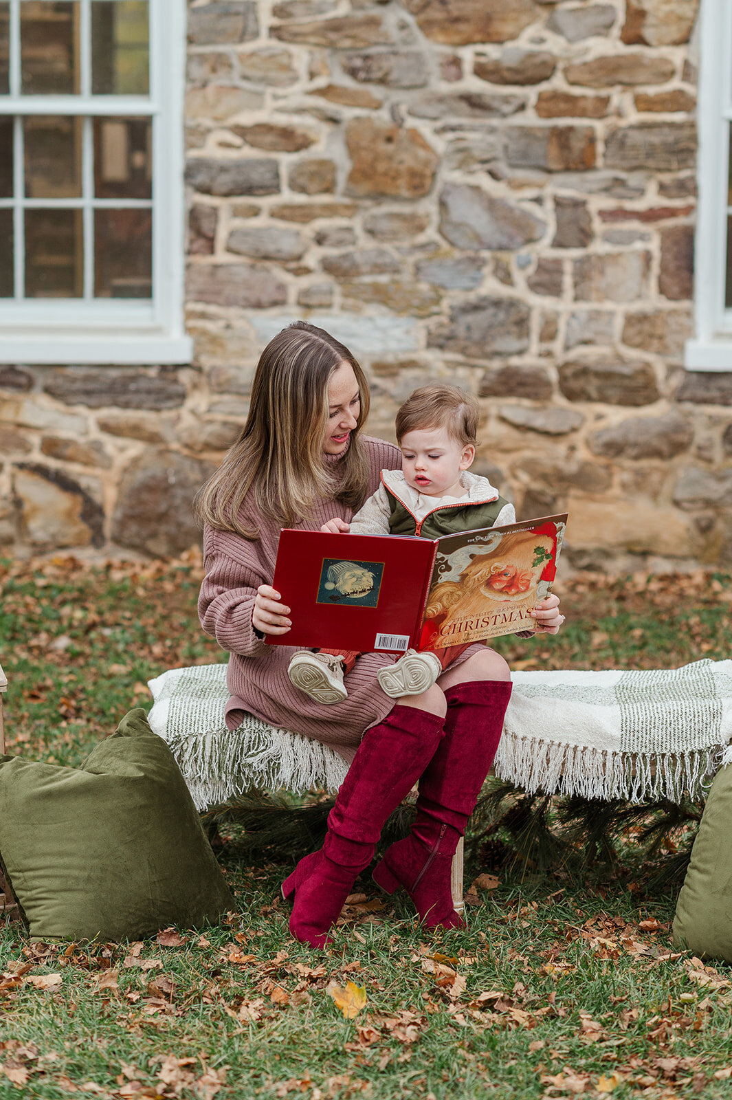 Mom and toddler reading a Christmas book during cozy  mini session in York, PA