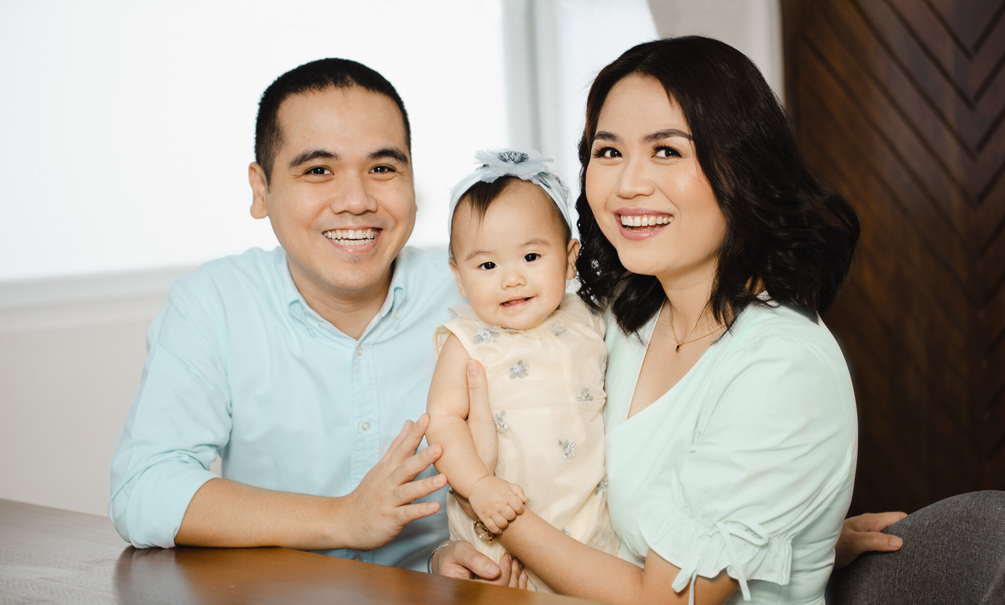 family of three all smiling