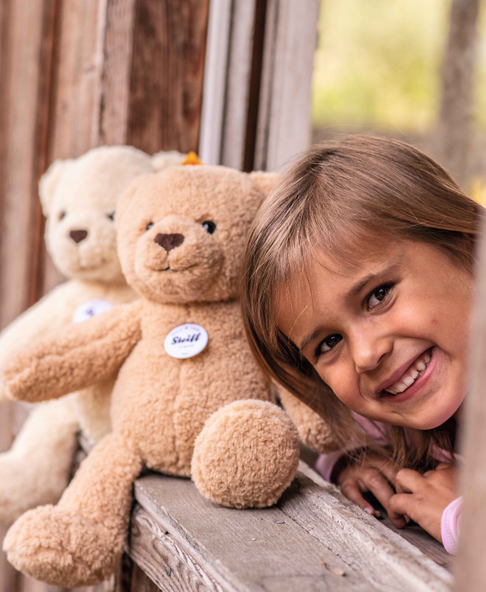 little girl with a steiff teddy bear