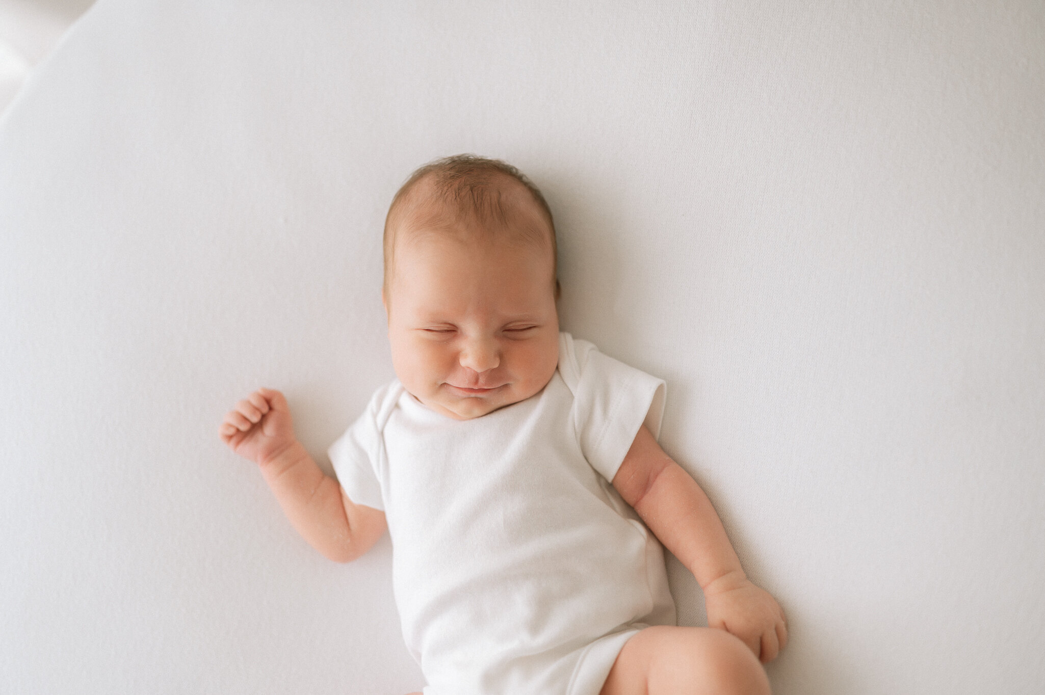 newborn baby smiling at York based photography studio