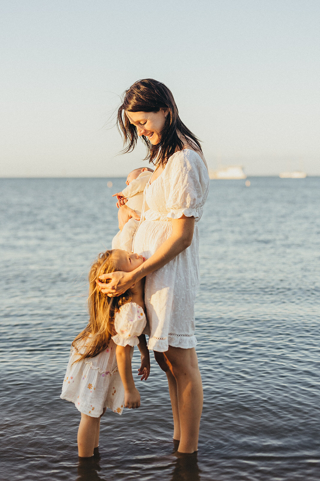 mother and her daughter having photos at the brisbane beach wellington point