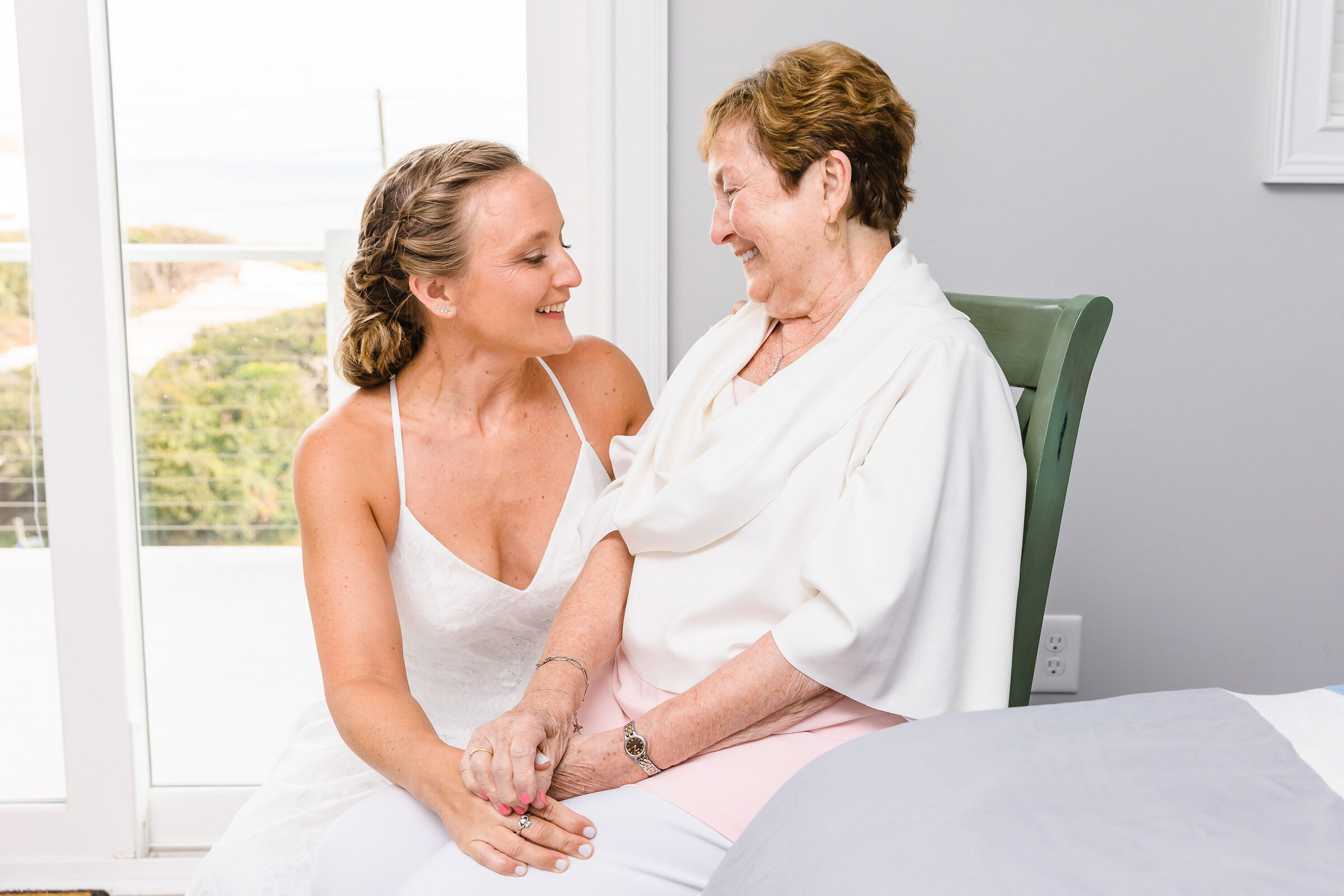 "Bride shares a sweet moment with her grandmother before her wedding in Topsail Island NC"