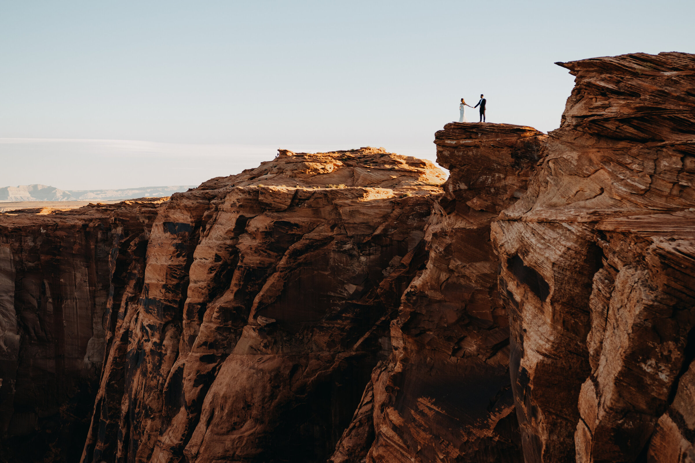 bride and groom on a cliff
