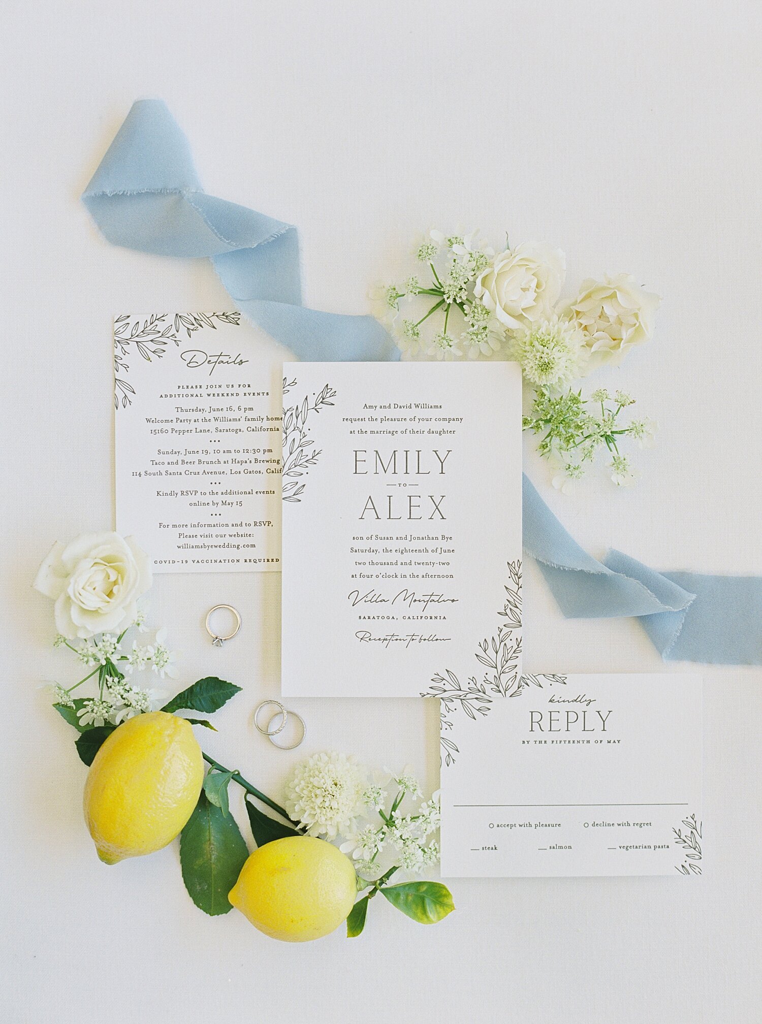 wedding invitations with blue ribbon and lemons and rings
