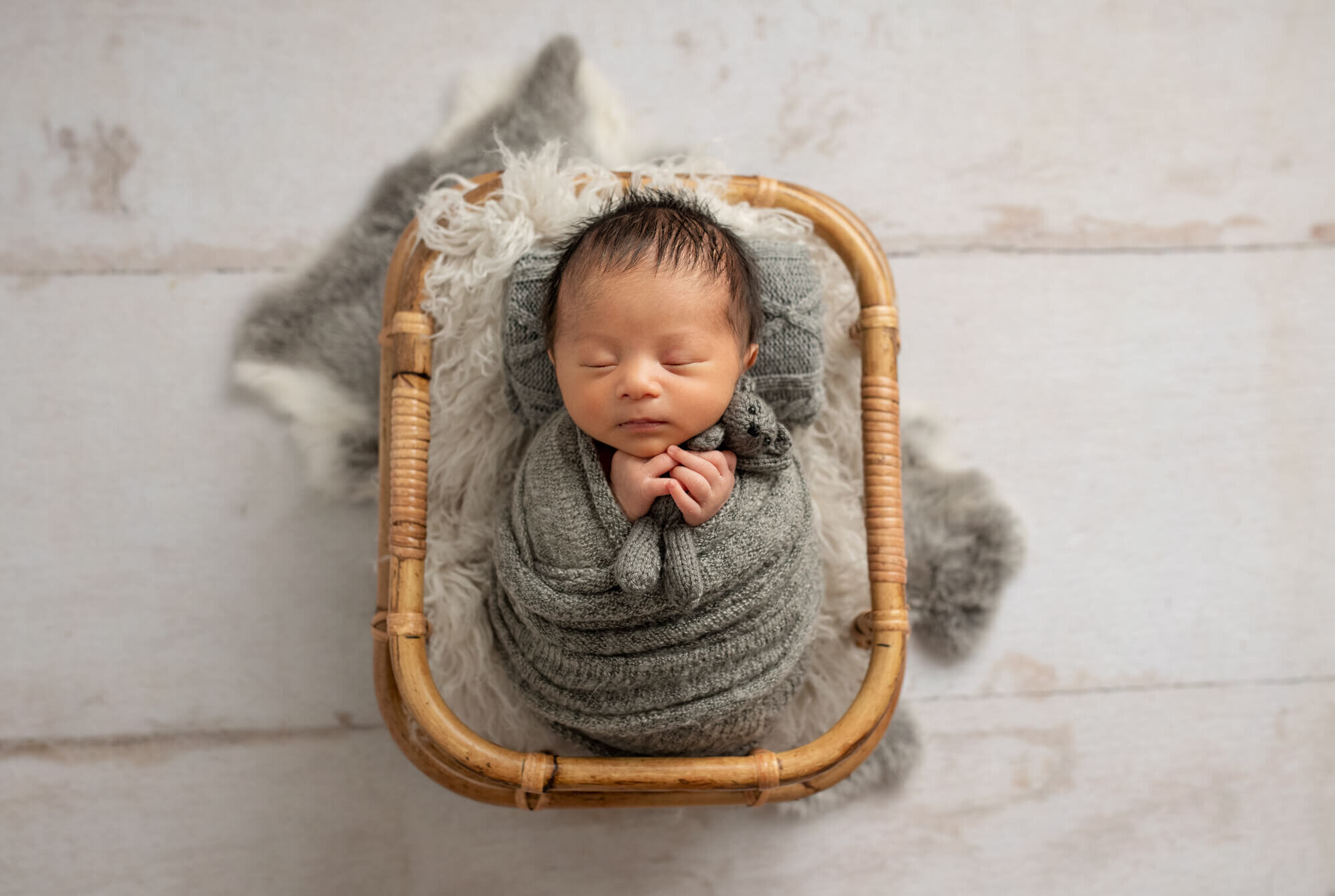 baby boy wrapped ini grey with teddy bear