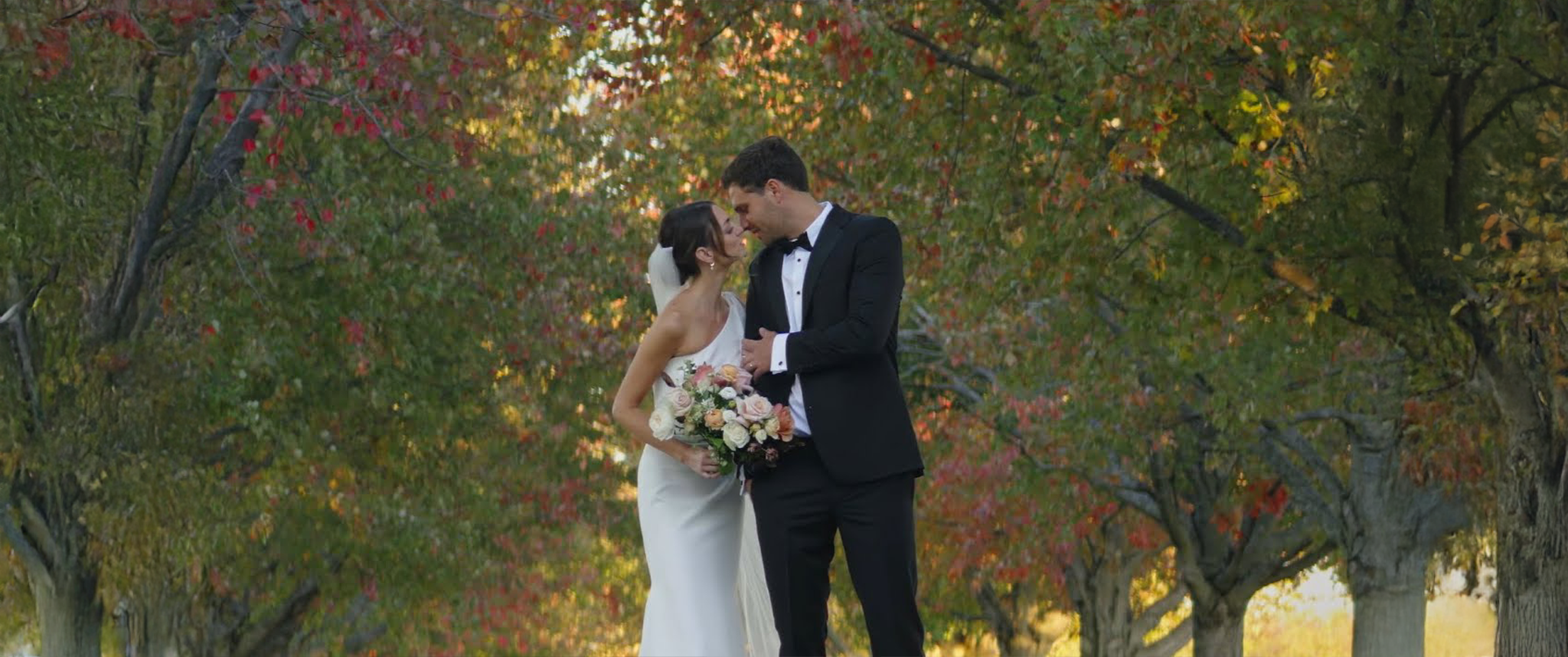 Video thumbnail of Claire and Sam Giammalva’s wedding at Haven on the Farm in Peoria, Illinois, highlighting the intimate outdoor setting, Claire’s radiant bridesmaids, Sam’s dashing groomsmen, and a special moment with Claire’s grandmother serenading the couple during the ceremony.