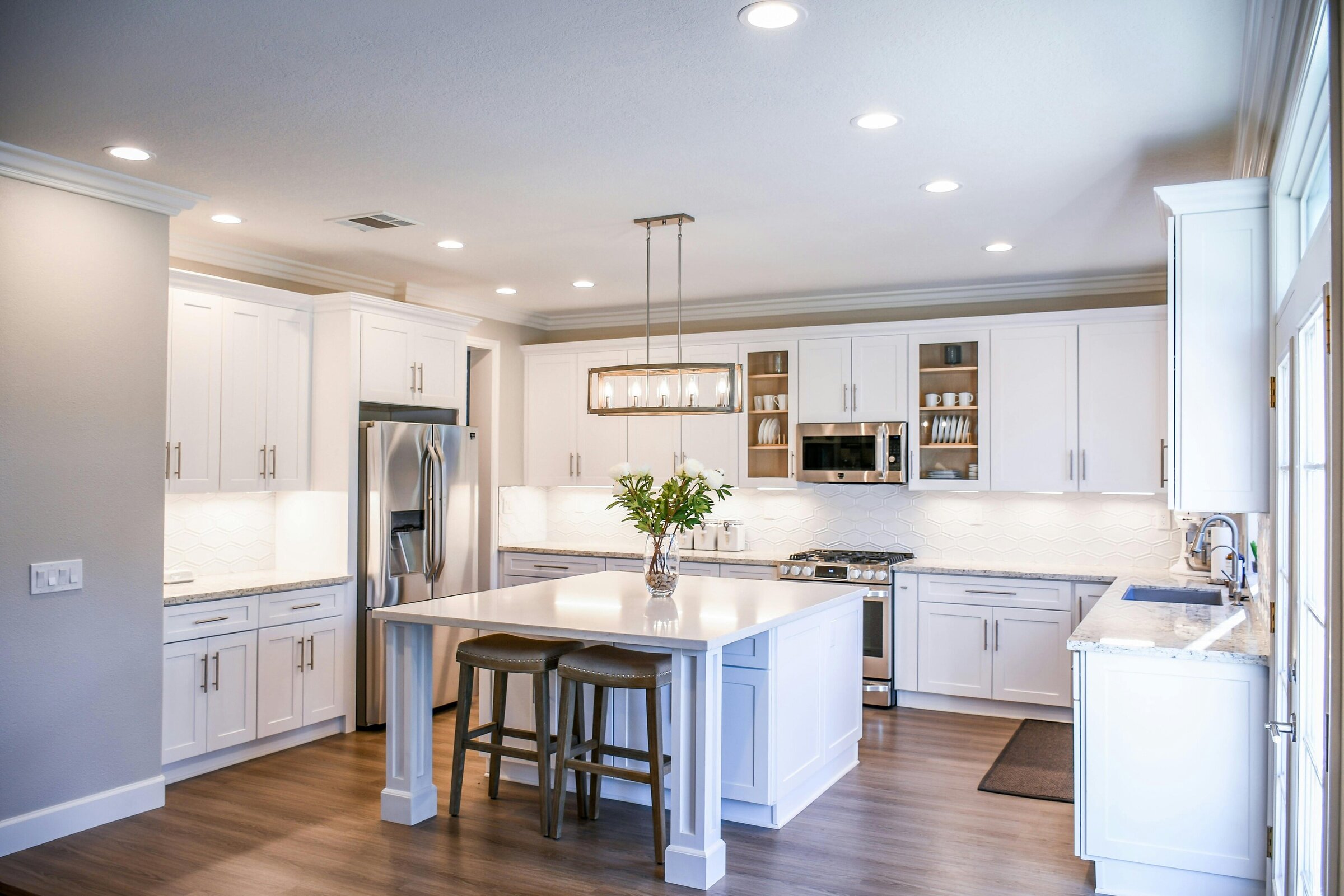 Full kitchen design and remodel in Farmington, Connecticut with all white countertops and cabinetry.