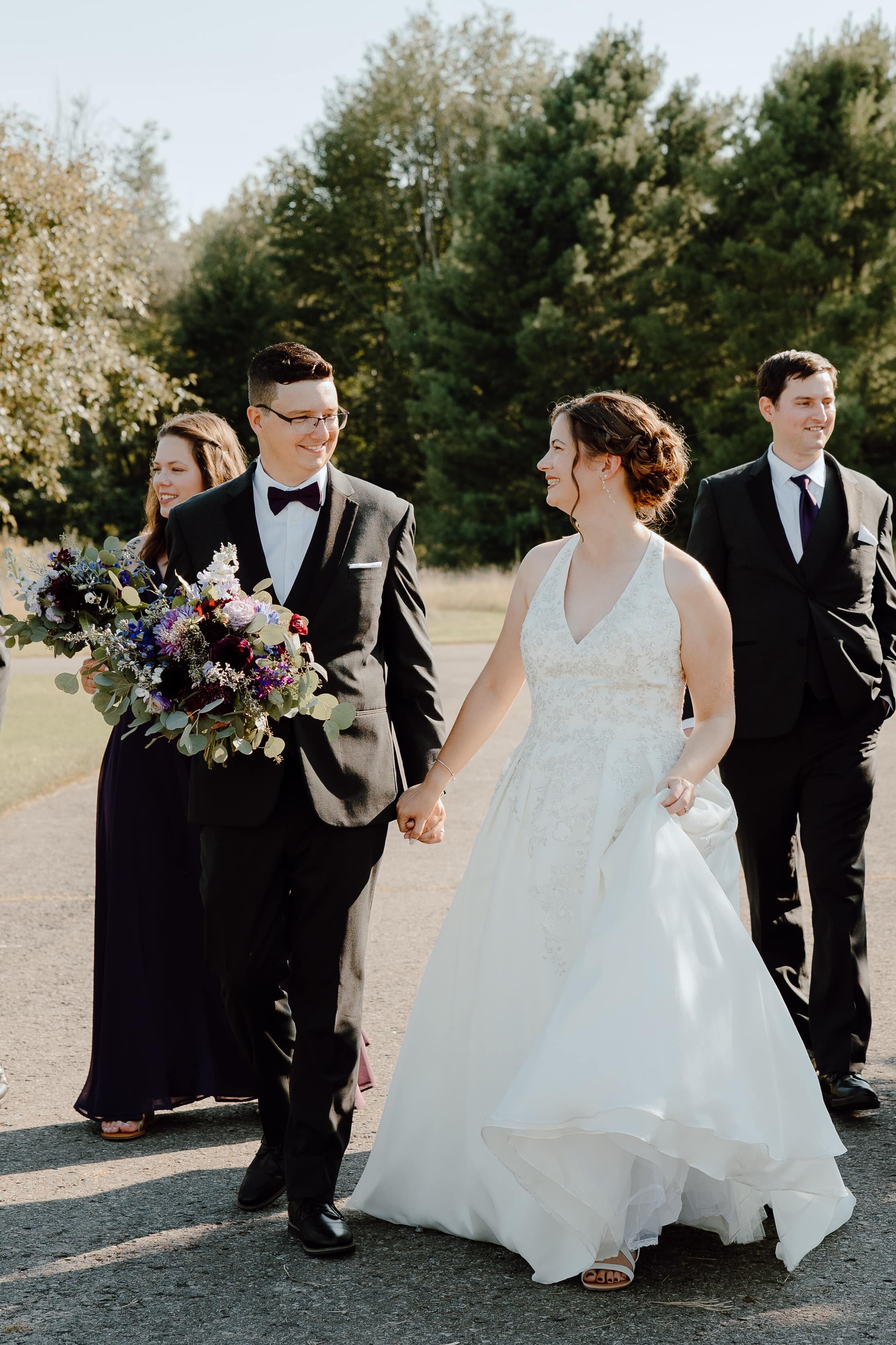 groom holding bride's bouquet