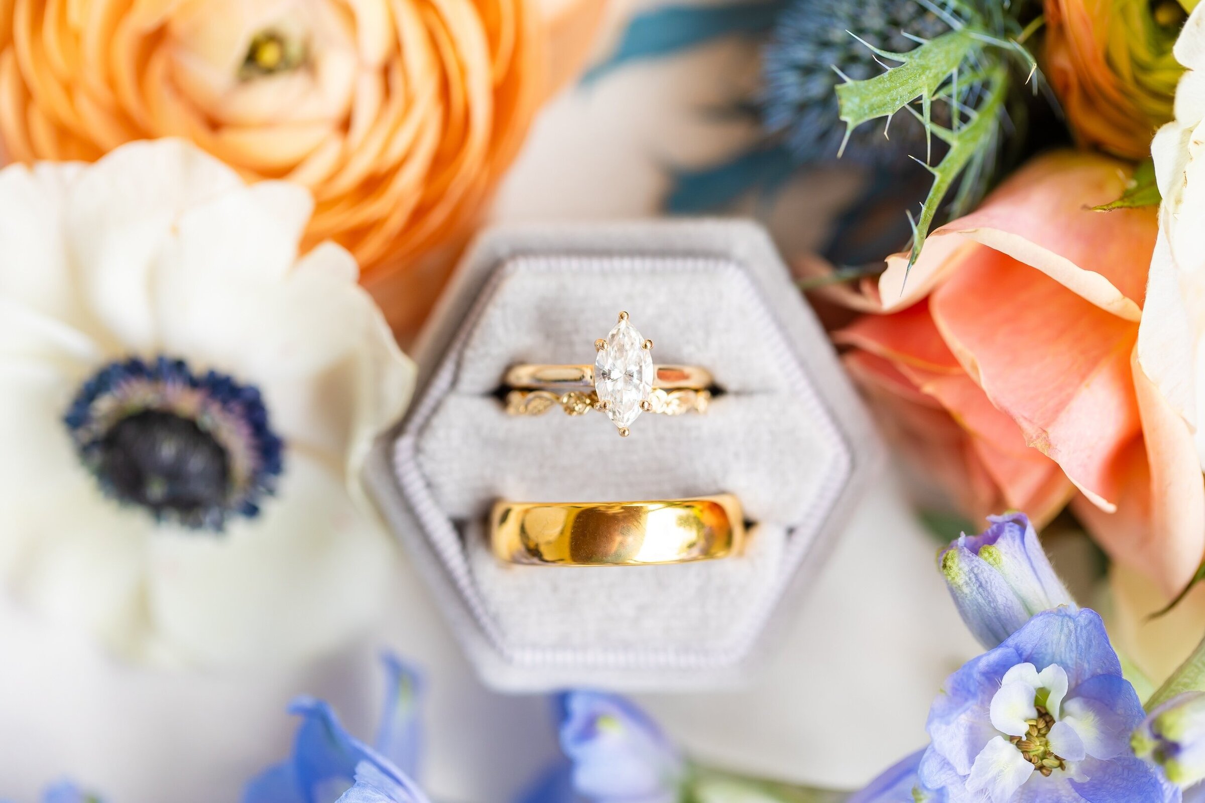 Bride and groom's rings next to flowers