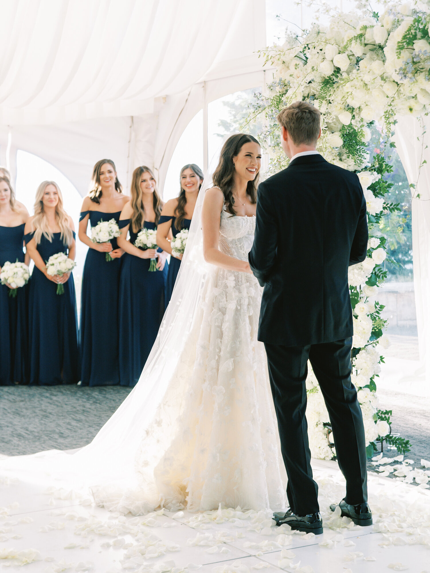 bride smiling at groom at ceremony