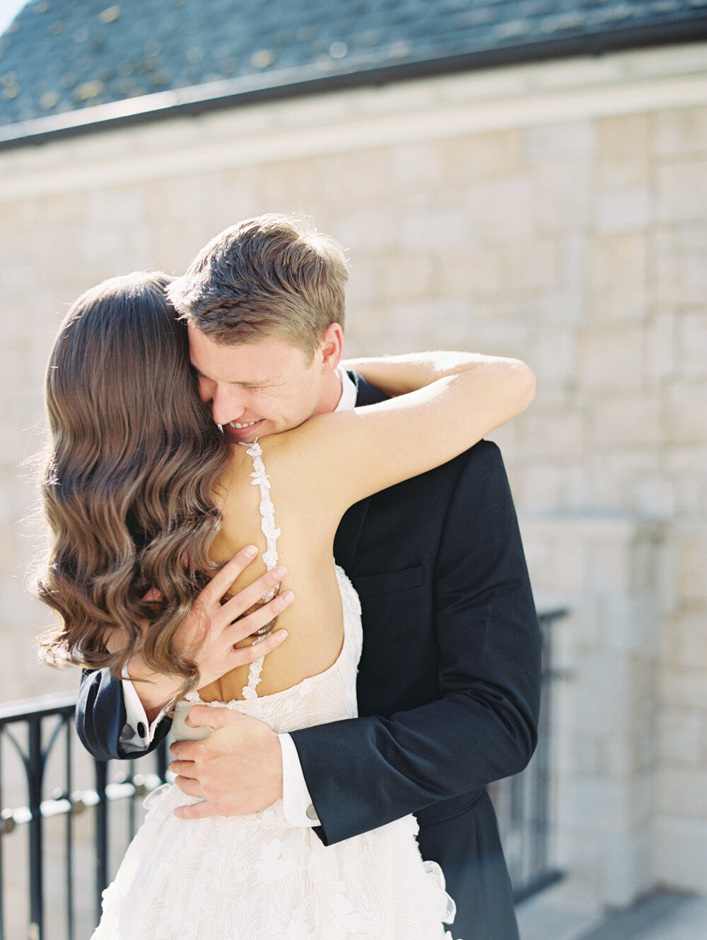 bride and groom hugging at the first look