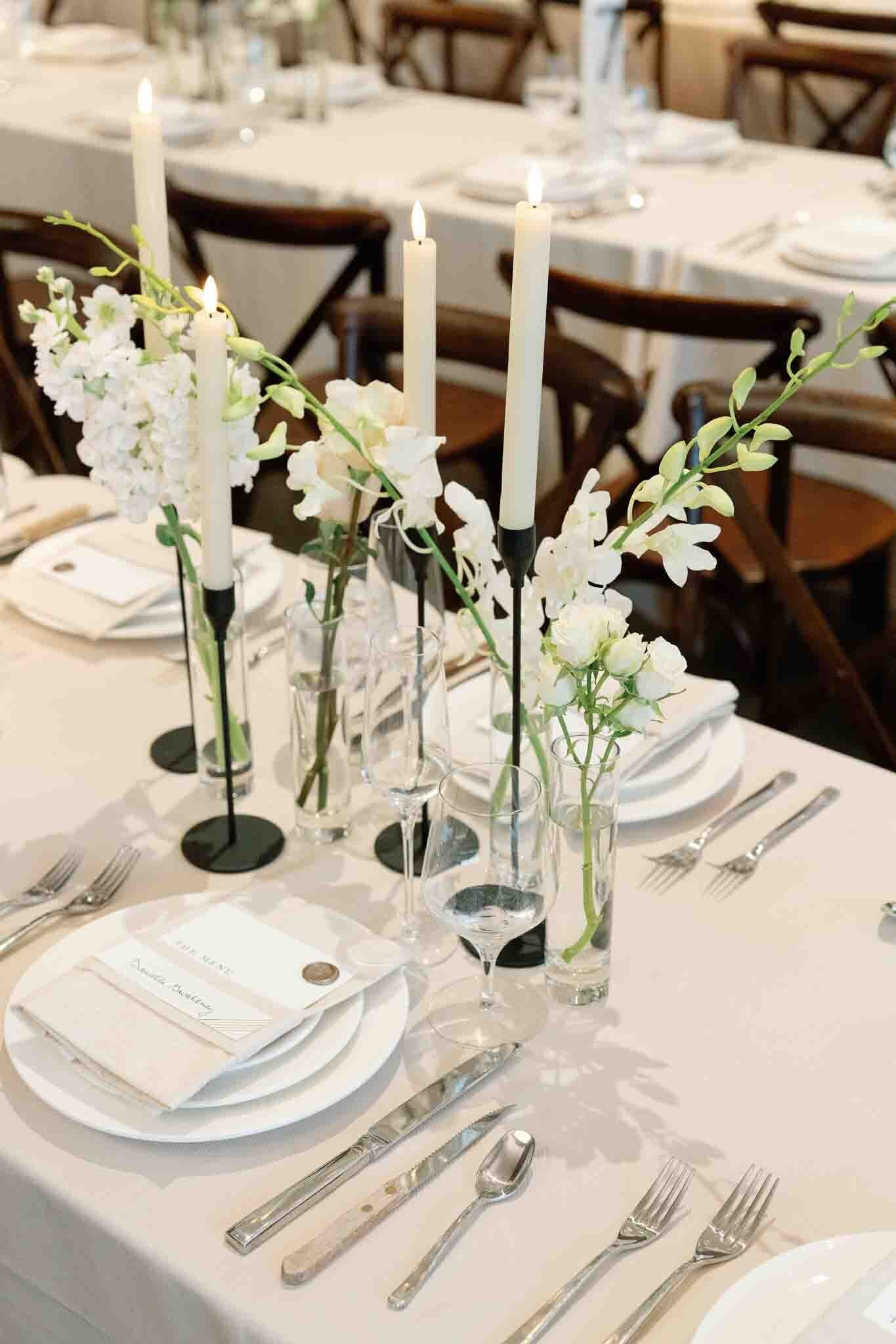 Elegant wedding table setting with white florals and candles