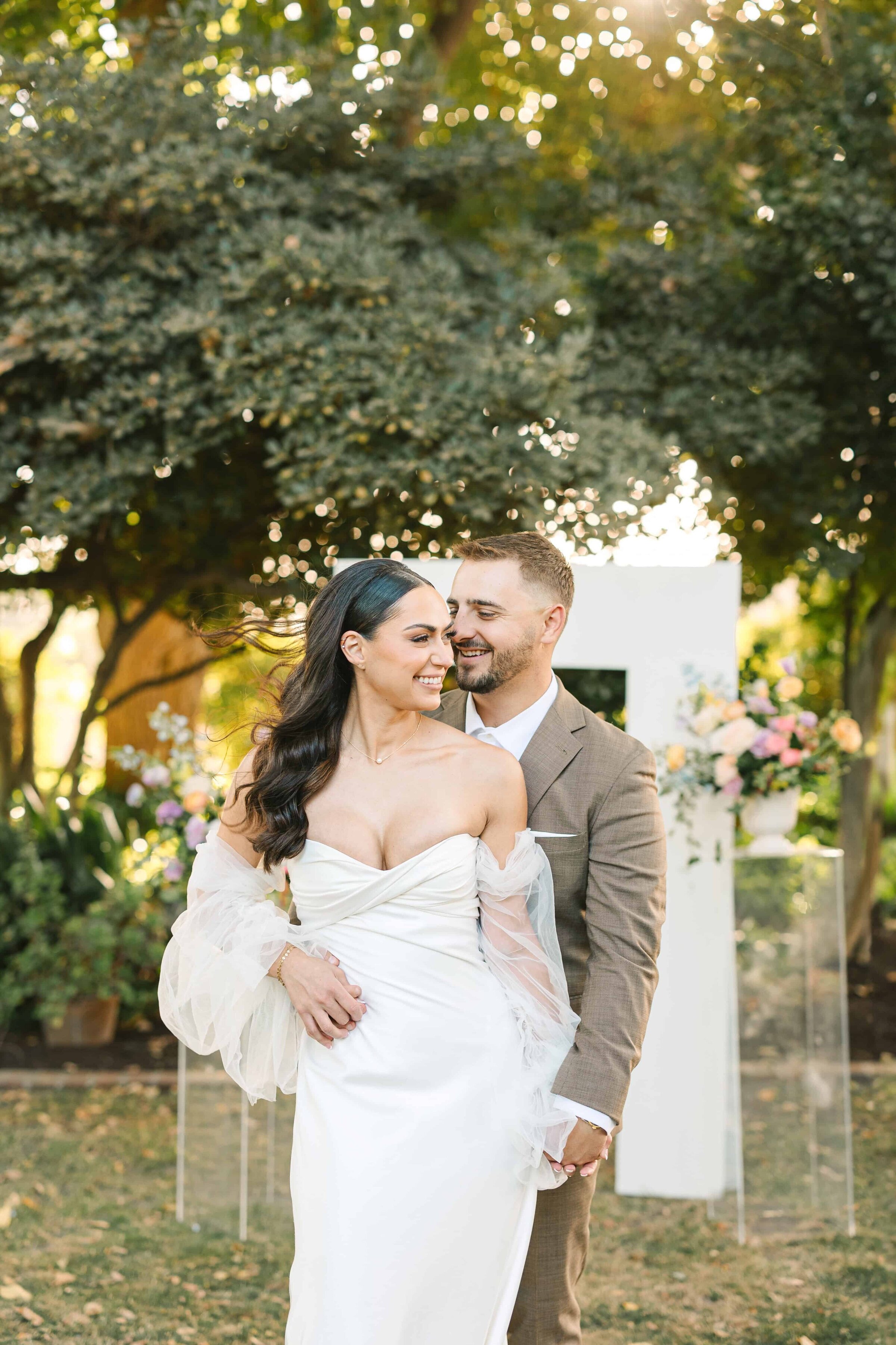 bride and groom posing for  wedding photos in fresno