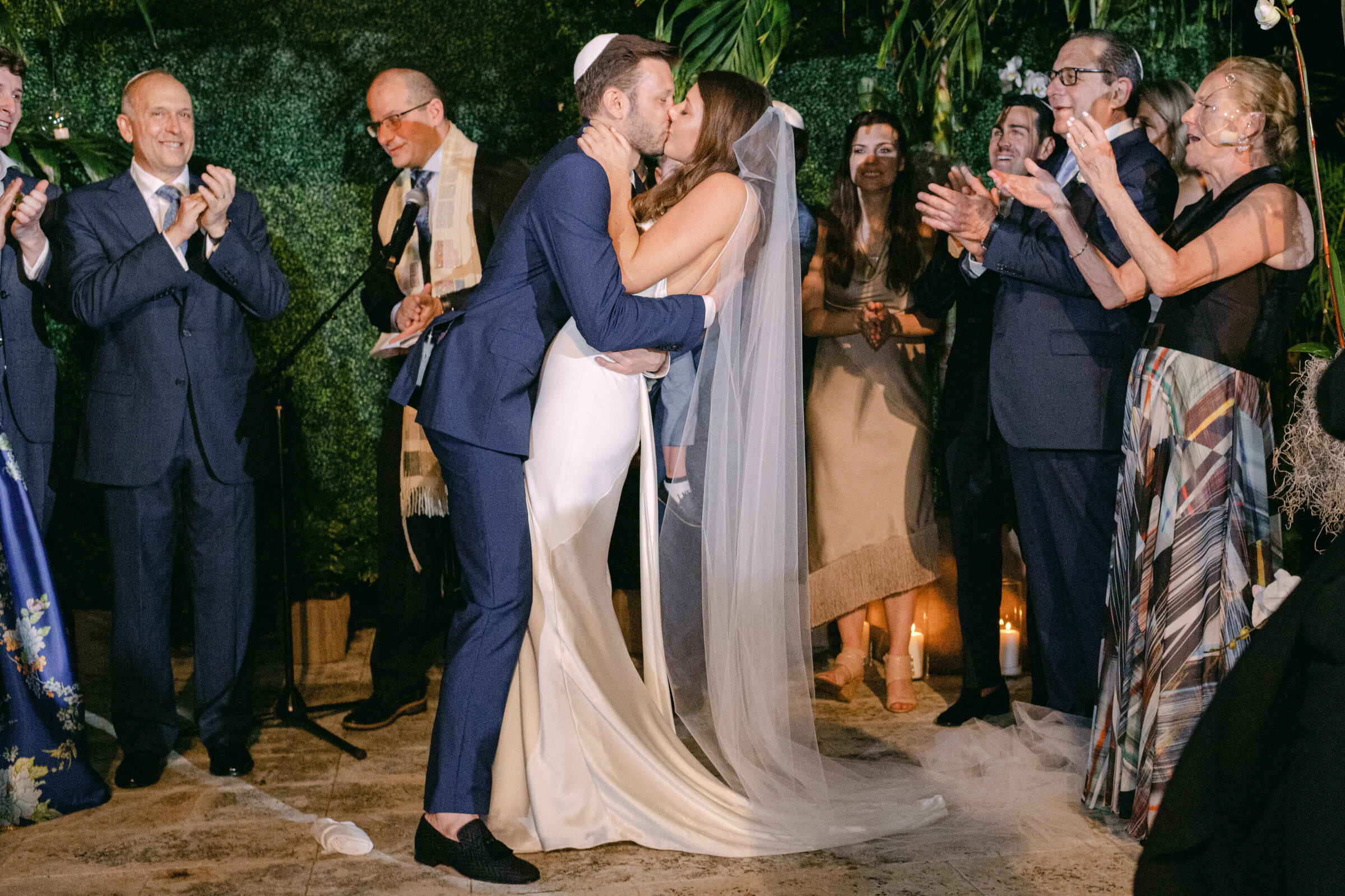 Bride and groom smiling under the chuppah during an intimate Jewish wedding ceremony in Washington DC, captured by Mari Harsan Studios.