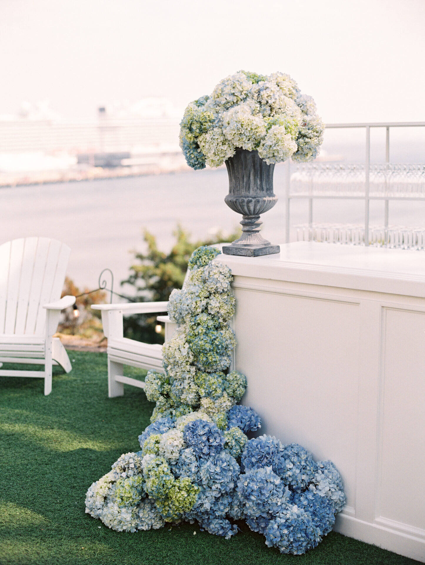 blue hydrangeas adorning a white wedding bar outside in seattle