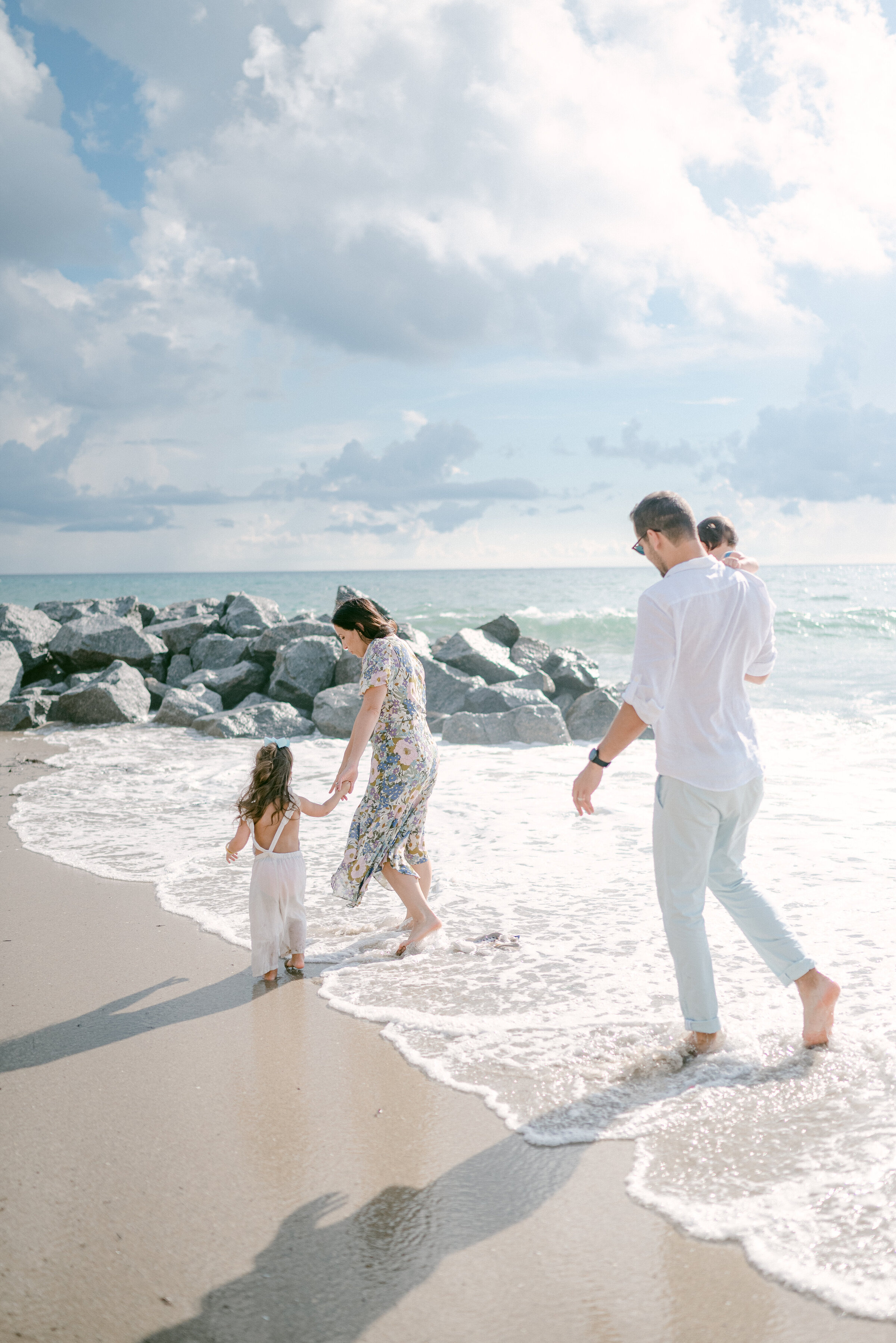 Family walking on the beach by Miami Family Photographer