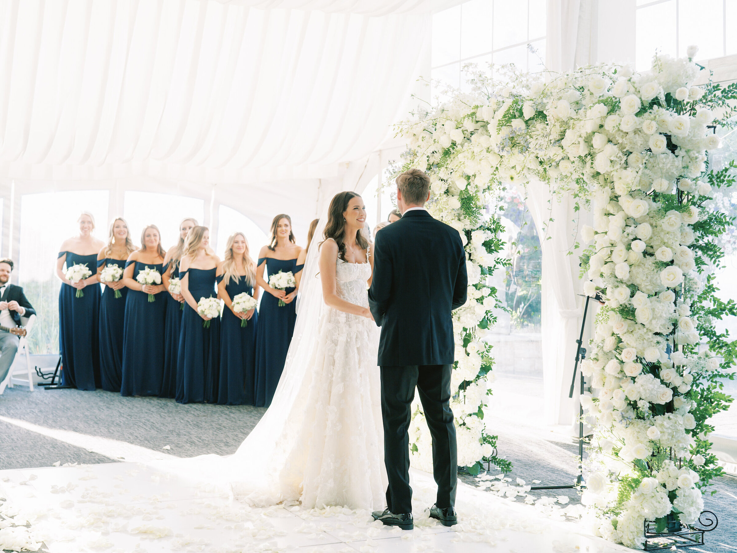 bride looking at groom smiling during ceremony