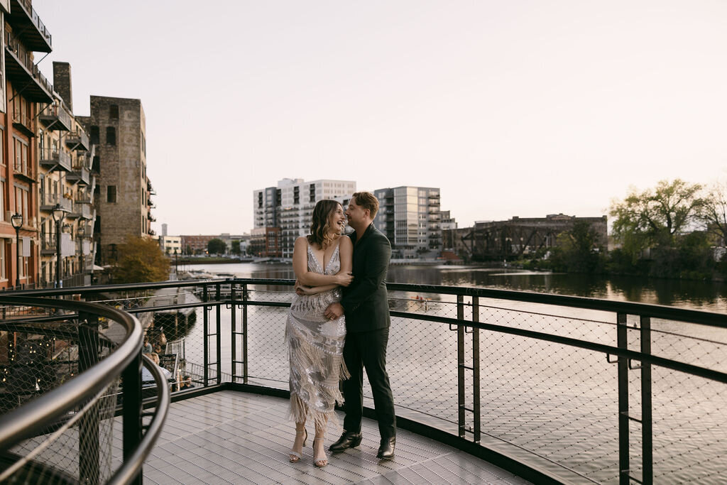 Engagement photoshoot on the Milwaukee River by Morgan Ashley Lynn Photography at sunset with bride and groom hugging and laughing