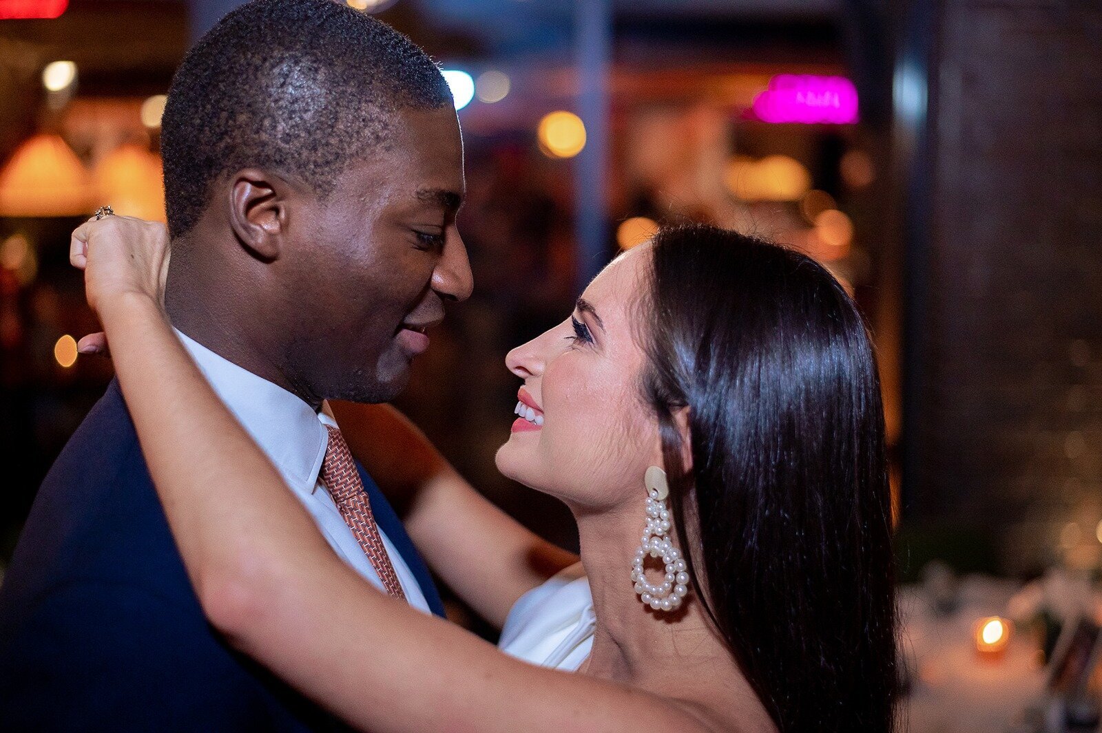 Engaged-inter-racial-couple-embracing-at-Moxy.