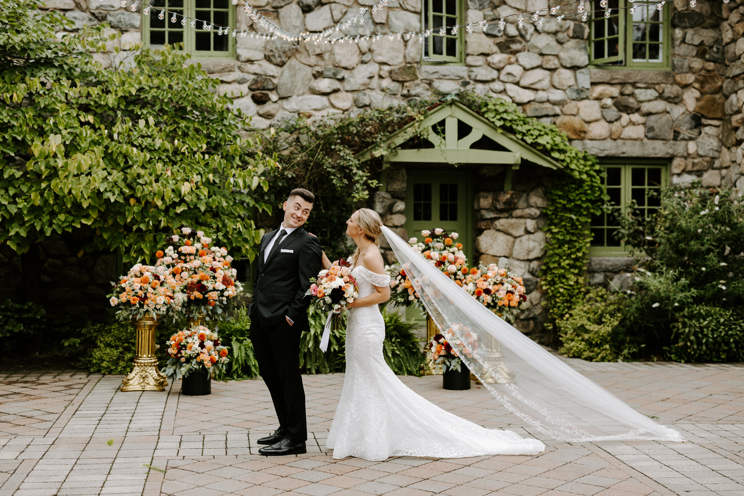 Bride walks up behind groom for first look at The Willowdale Estate in Topsfield, Massachusetts