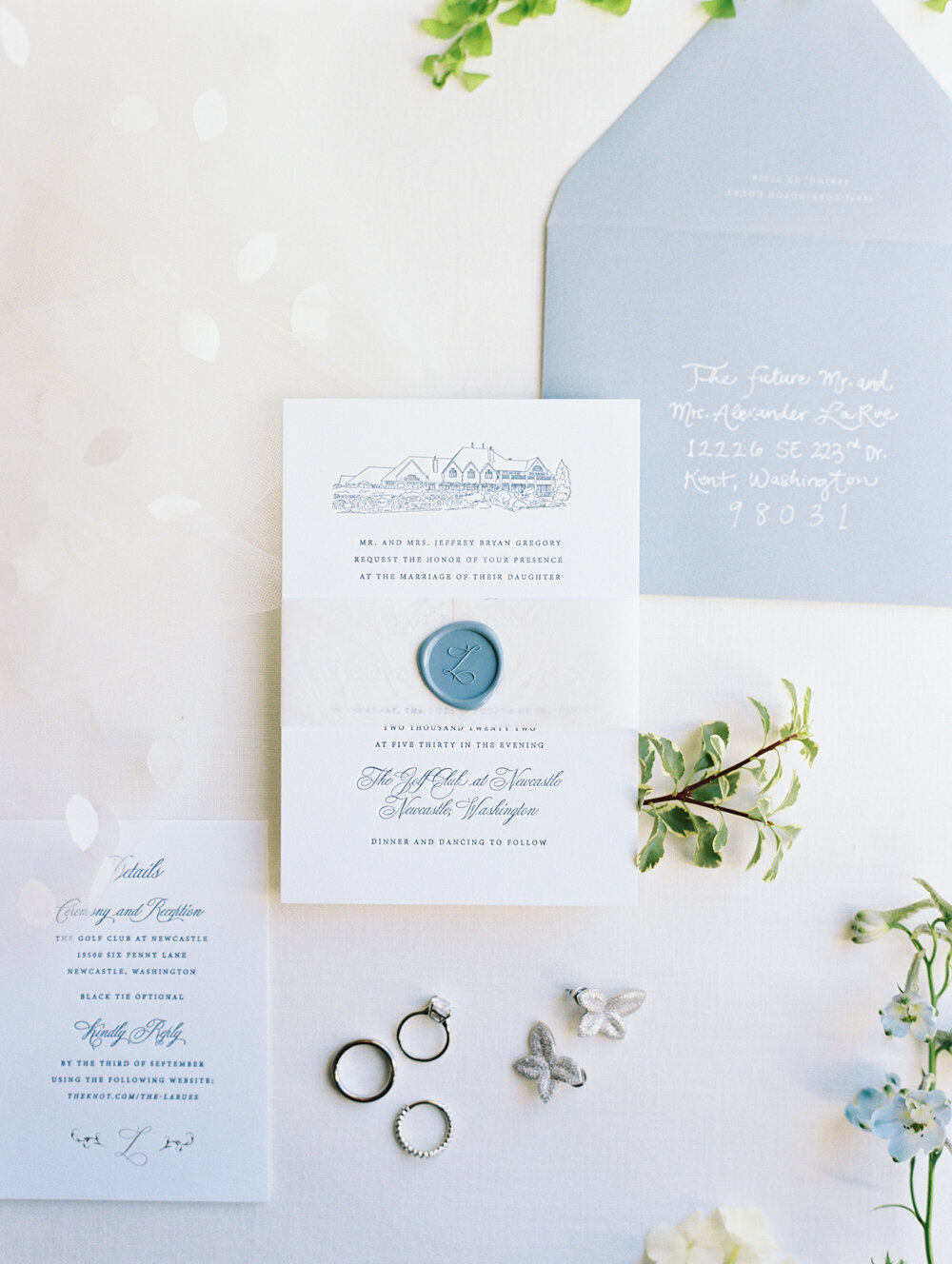 white and blue wedding invitations with wax seal and rings